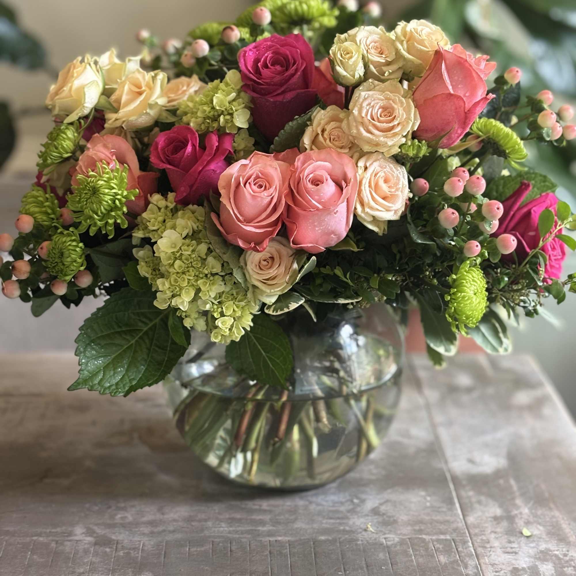 Mixed pink and cream roses in a clear glass vase