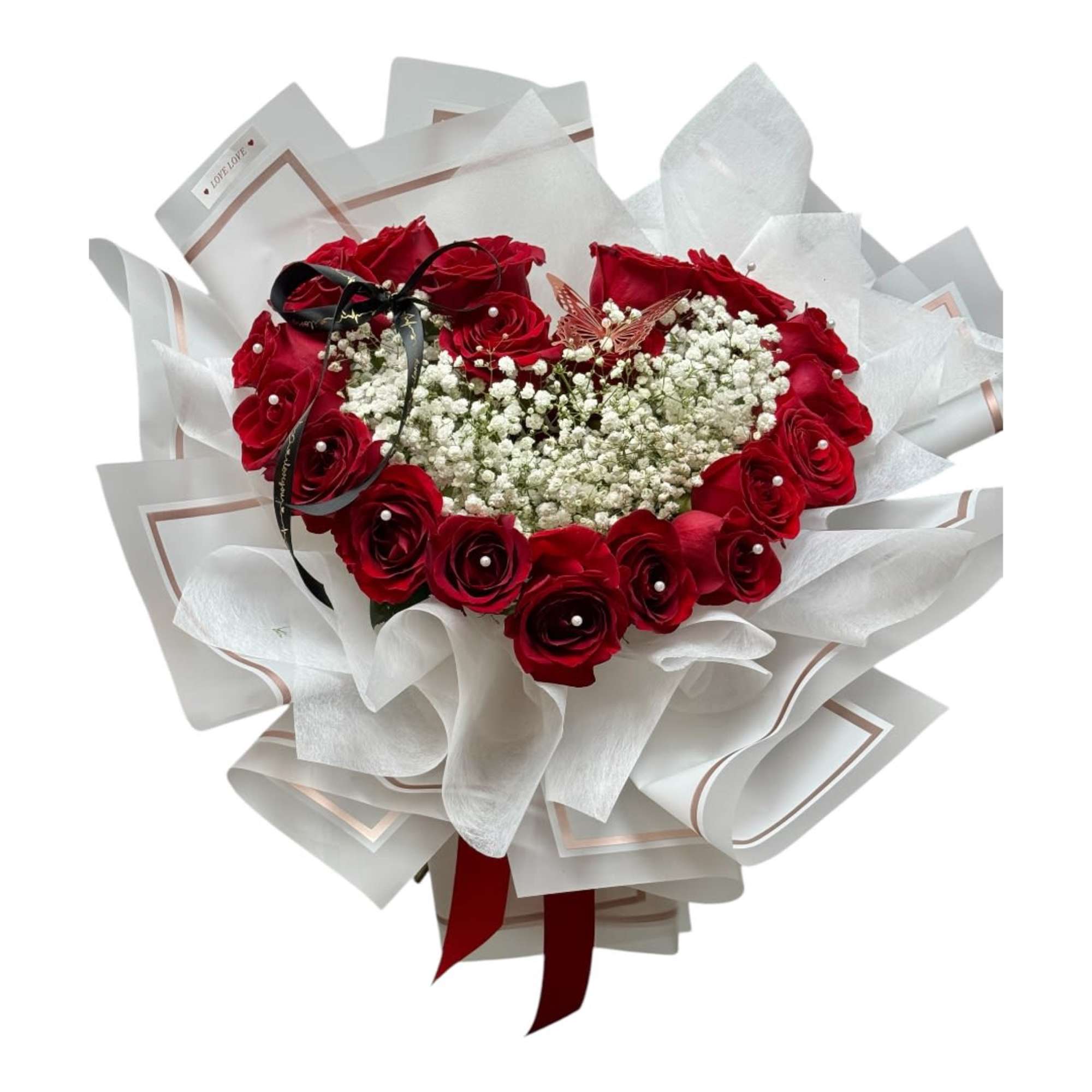 Heart-shaped bouquet of red roses with white filler flowers and white wrapping