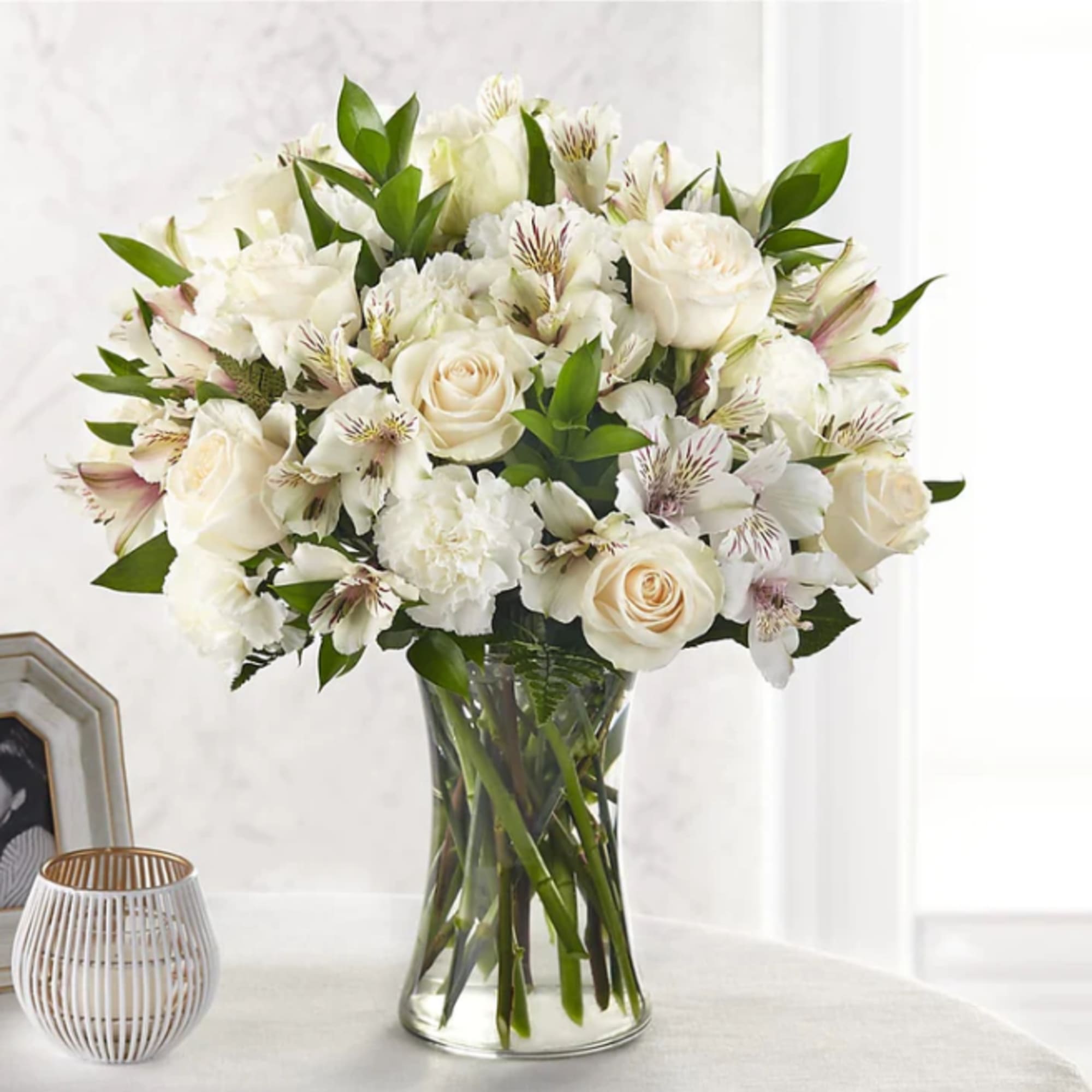 White roses and alstroemeria in a clear glass vase