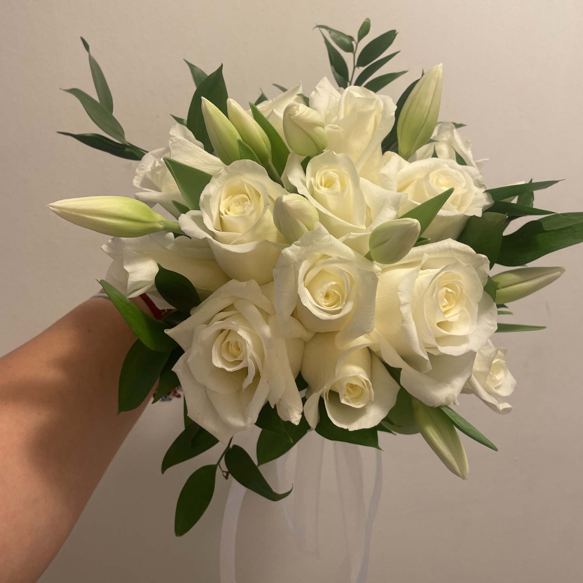 A classic white rose bouquet hand tied with ribbon. The perfect accessory