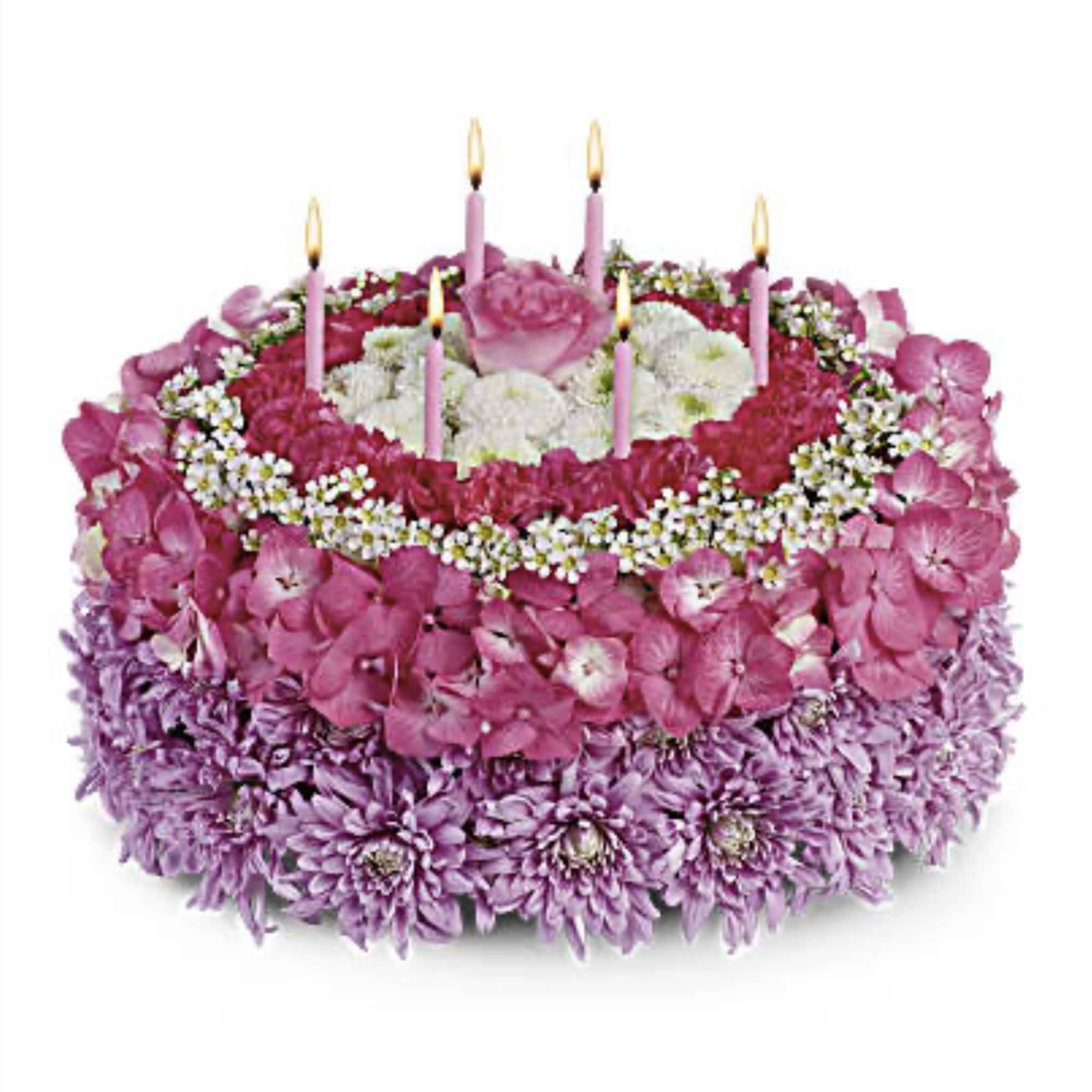Round pink and purple floral cake with lit candles