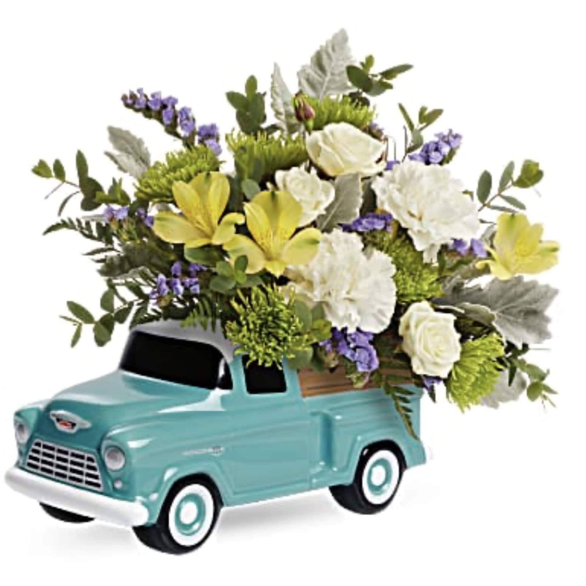 Flower arrangement in a turquoise toy pickup truck