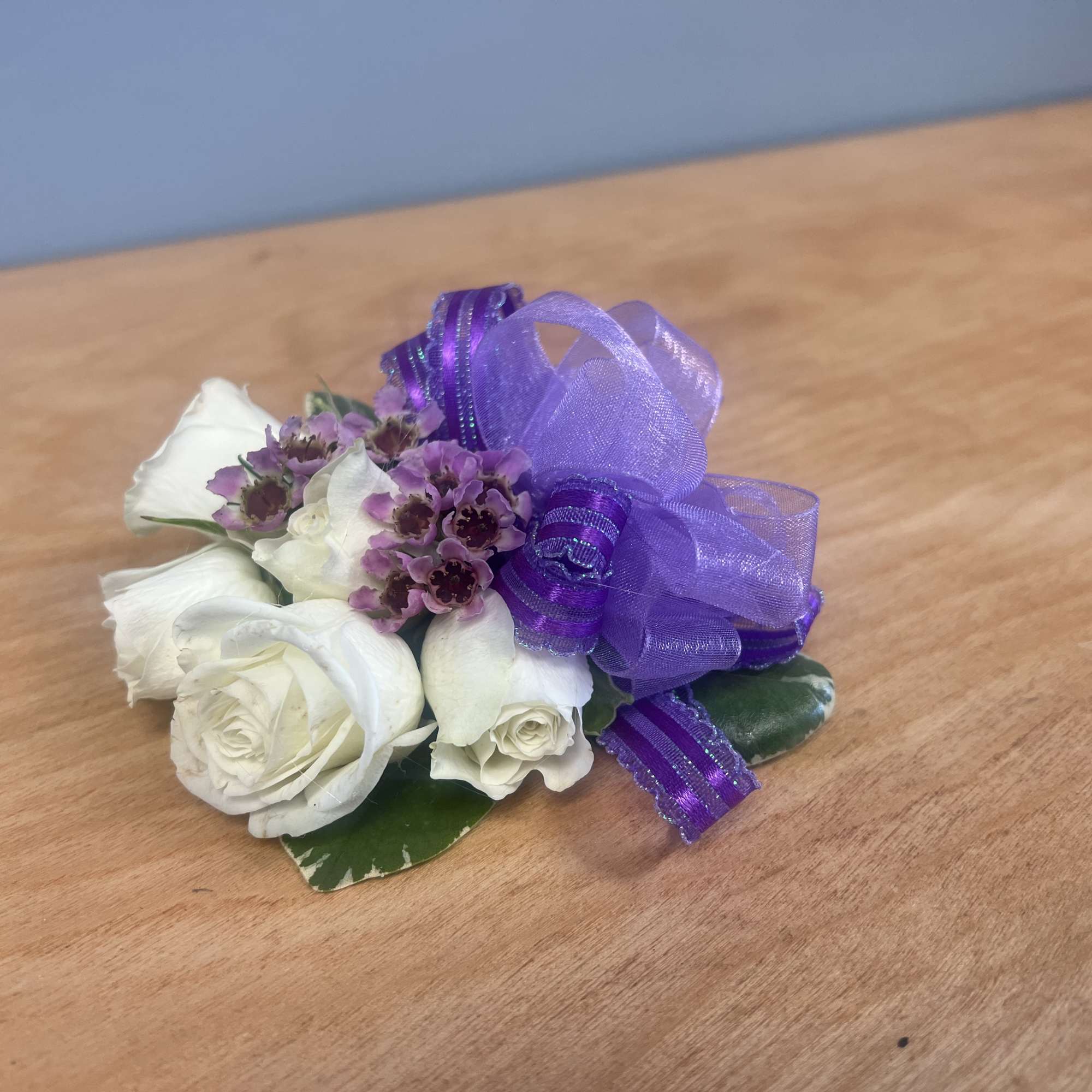 Lavender Corsage, with white spray roses, wax, and lavender ribbon.