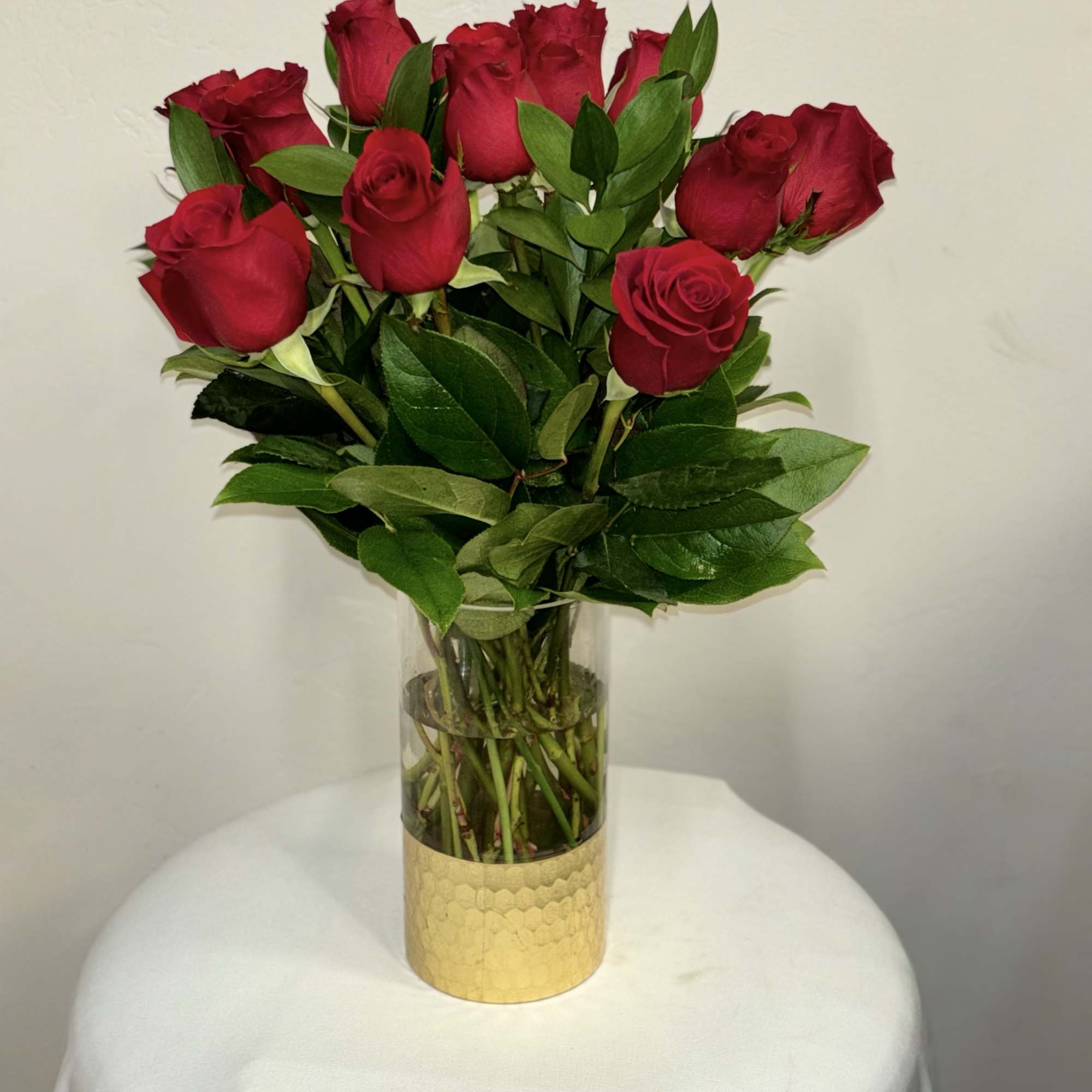 This arrangement features a dozen exquisite roses showcased in a clear vase