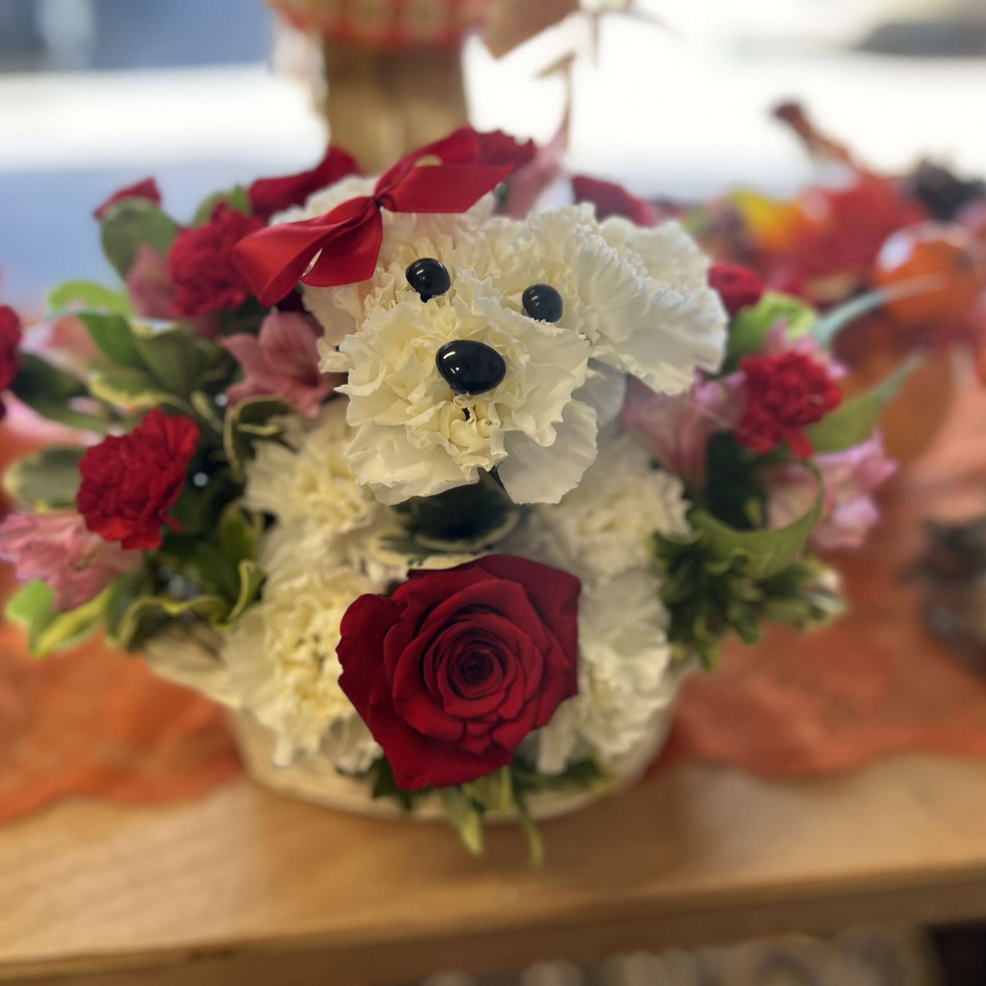 A cute Puppy with White carnations and a red rose., photo 2 of 2