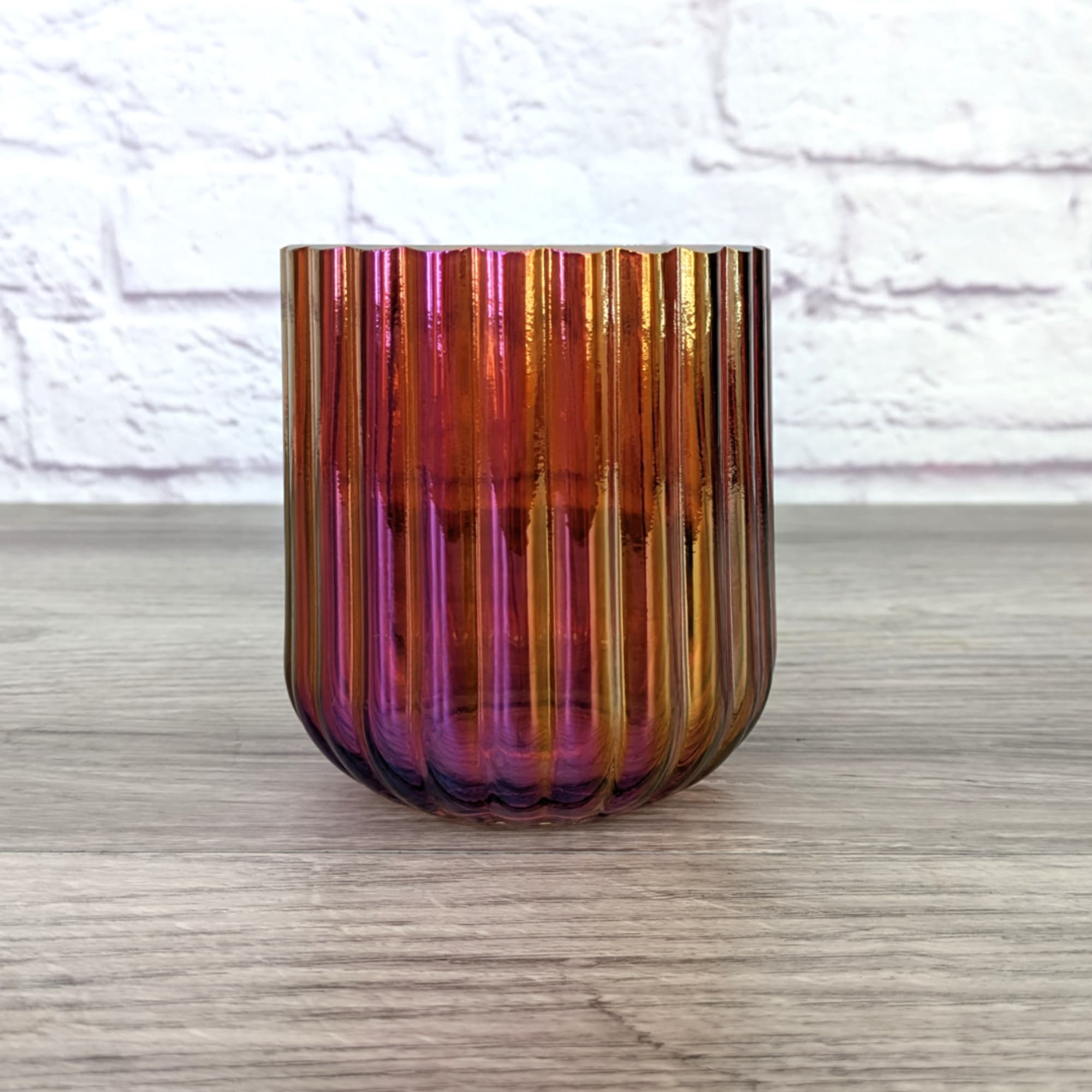 Iridescent ribbed glass vase on a tabletop