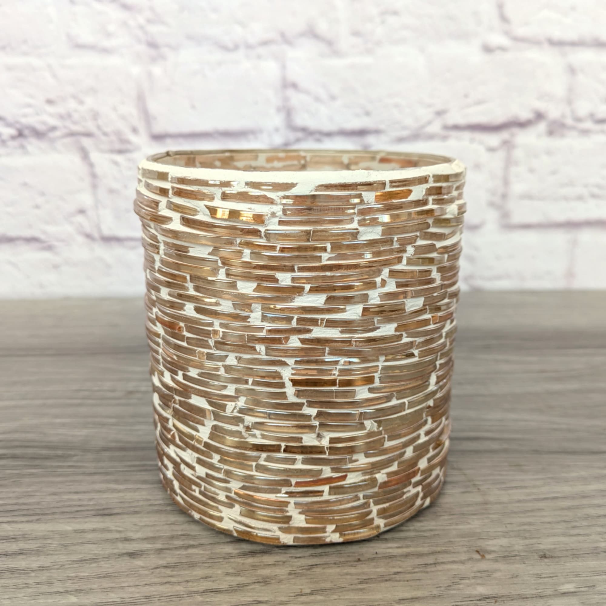 Textured cylindrical glass vase on a tabletop