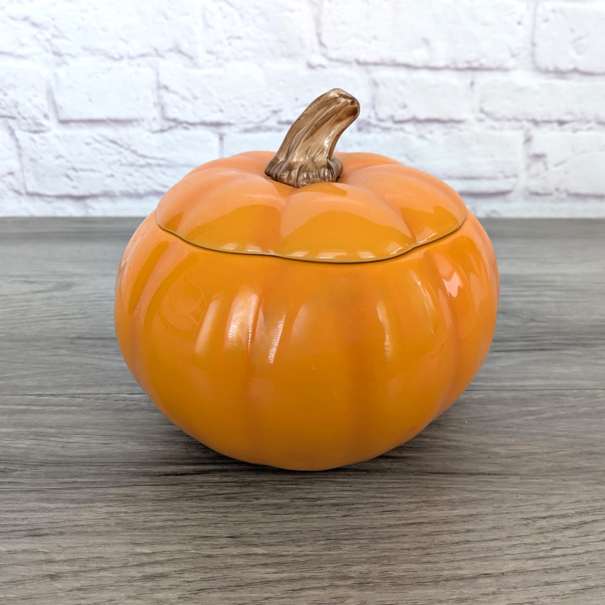 Orange pumpkin-shaped ceramic container with a lid