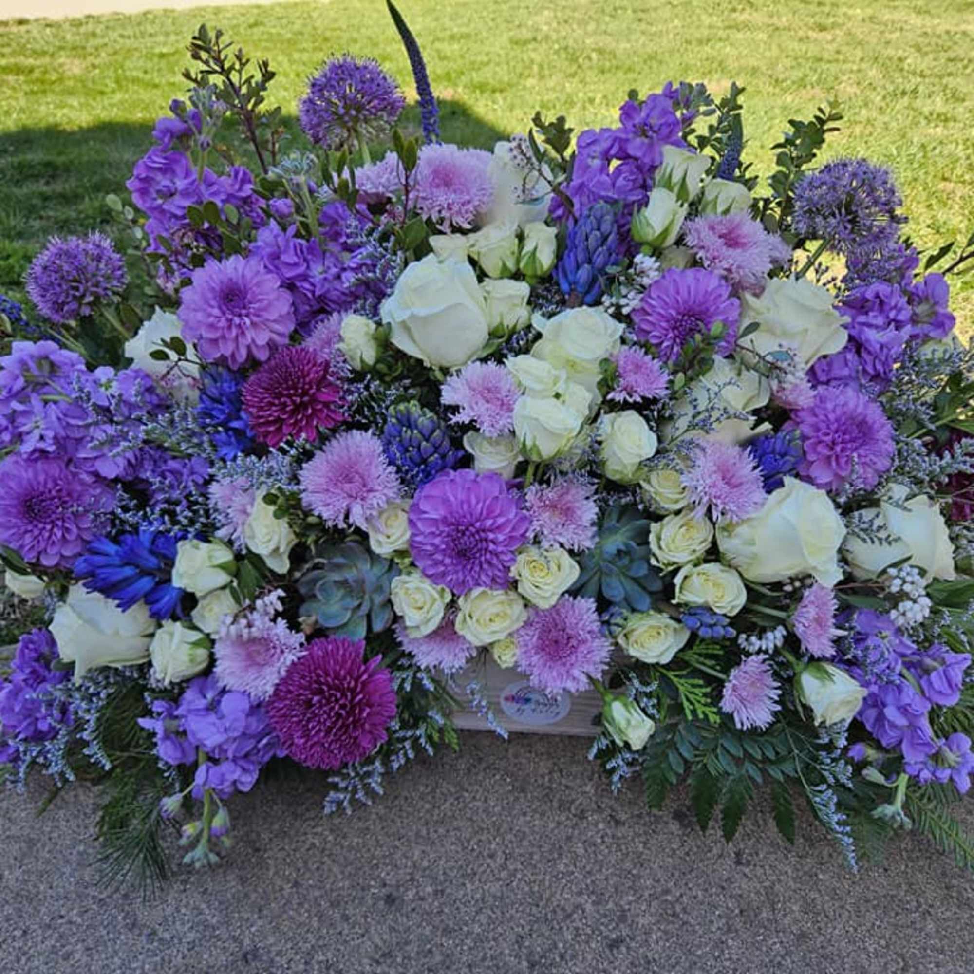 Large purple and white floral spray with roses and mums