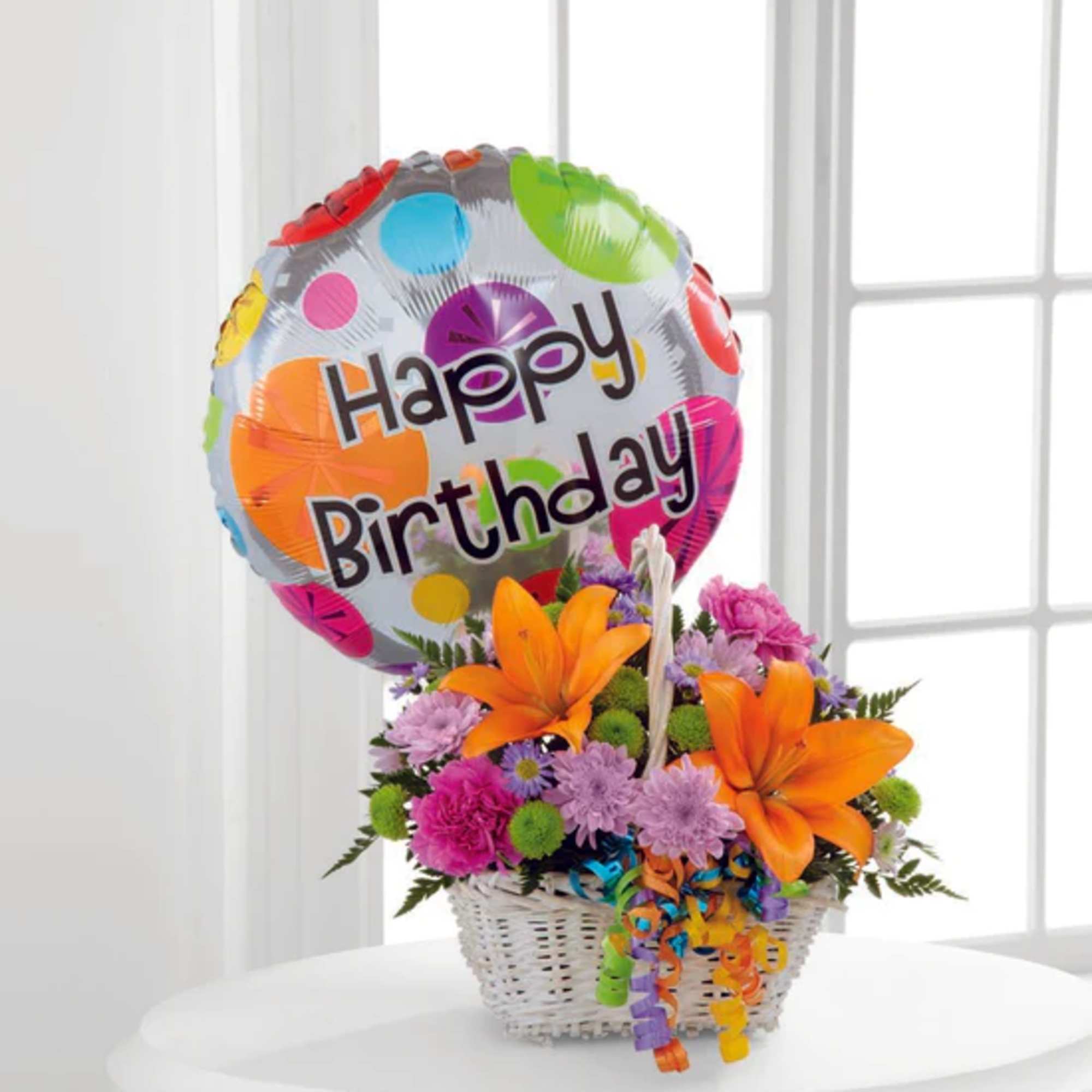 Happy Blooms Basket brings together Asiatic lilies and carnations to create the