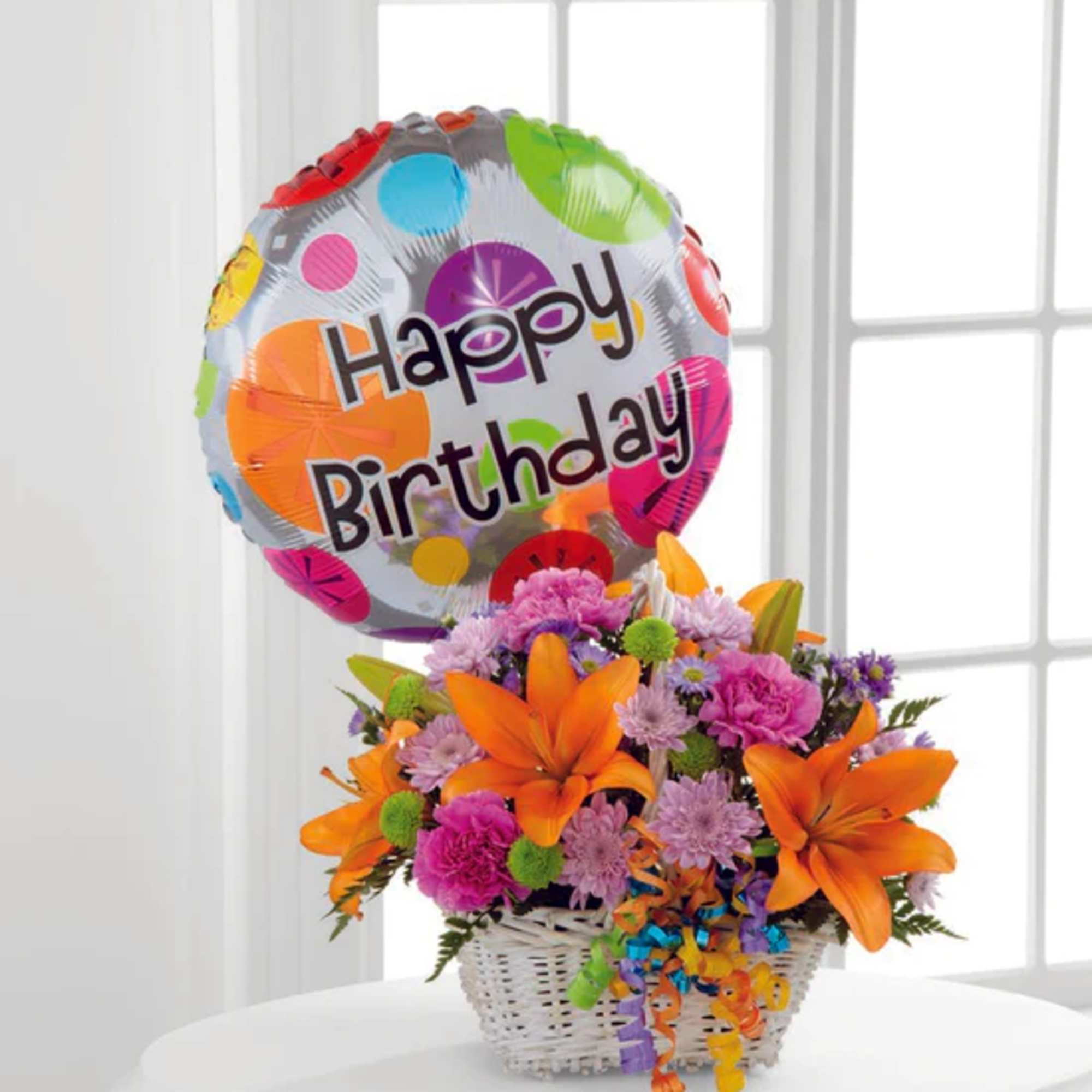 Happy Blooms Basket brings together Asiatic lilies and carnations to create the