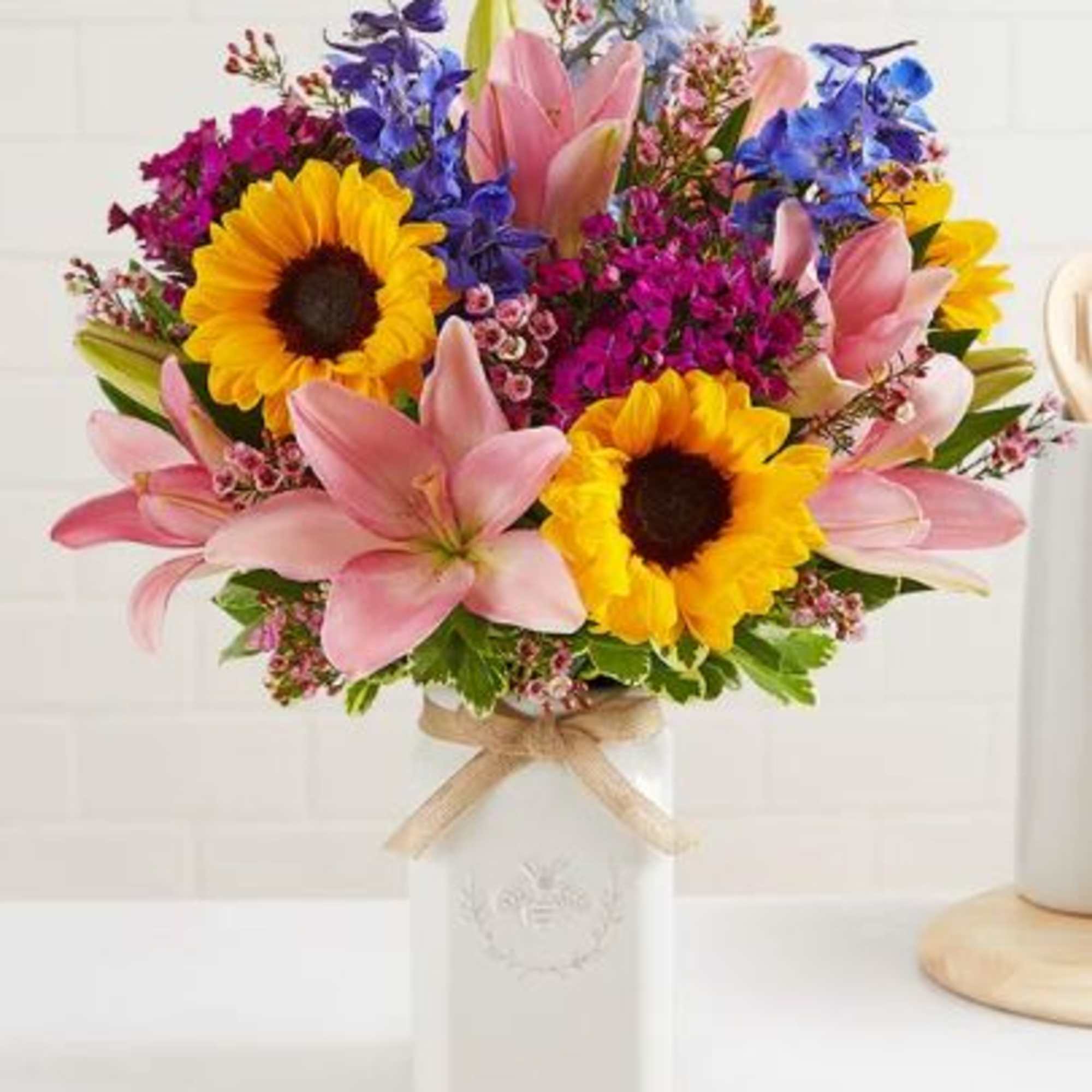 Get them buzzing with our charming bouquet! Sunflowers, Pink Asiatic Lily, Blue