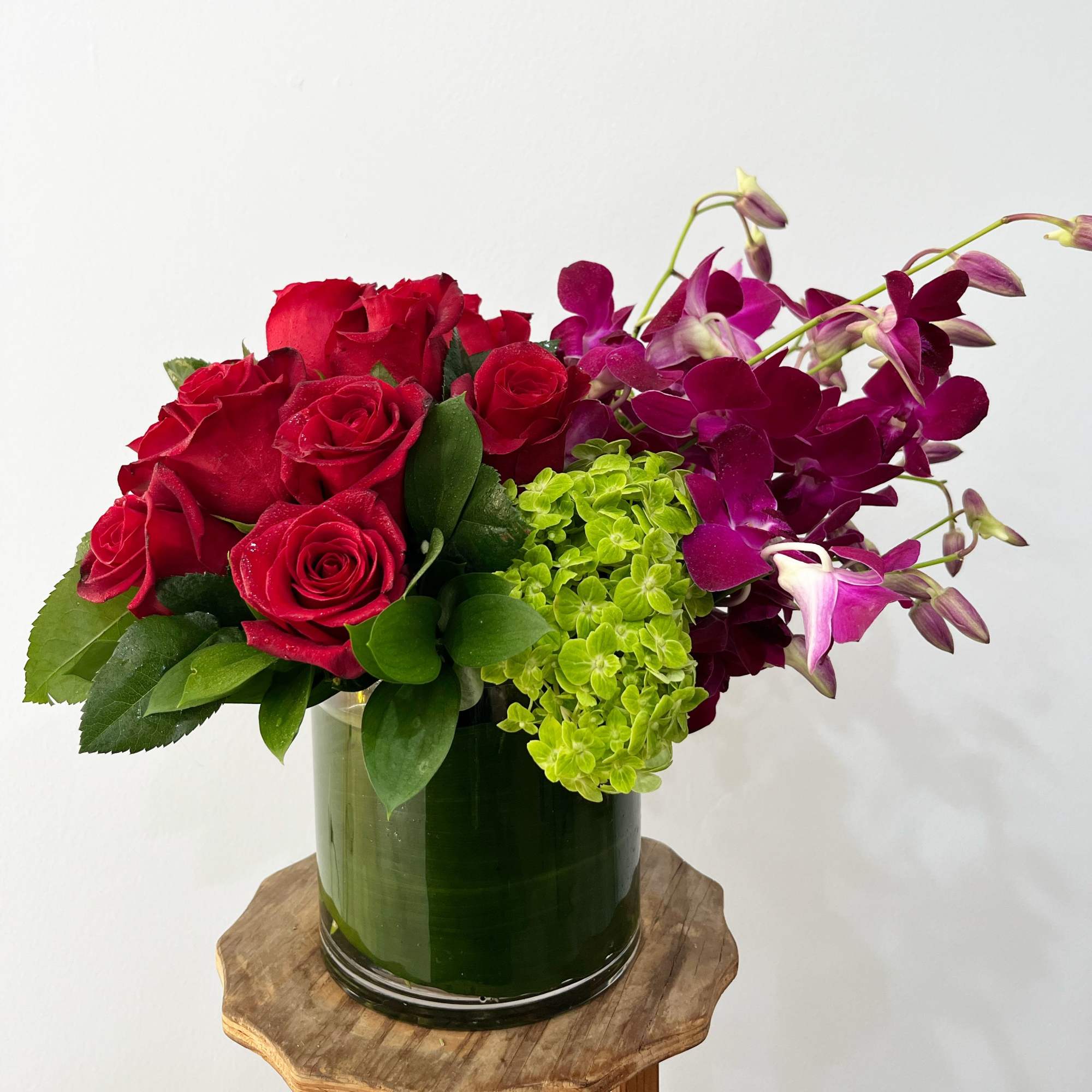 A celebration of luxury and life, this large and jewel toned arrangement