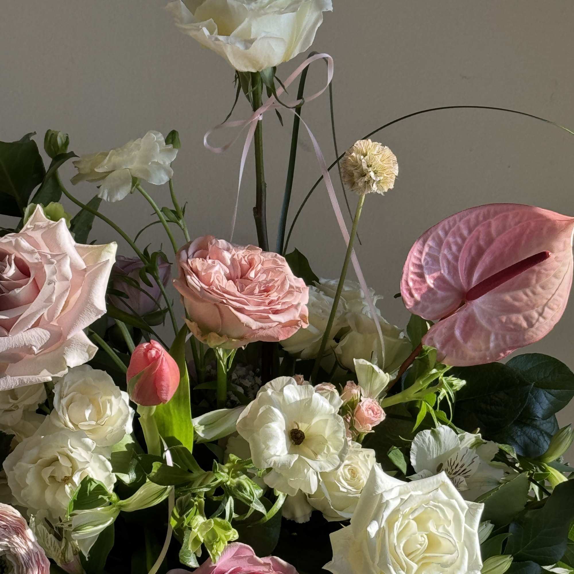 Mixed bouquet with pink and white roses, anthurium, and tulips