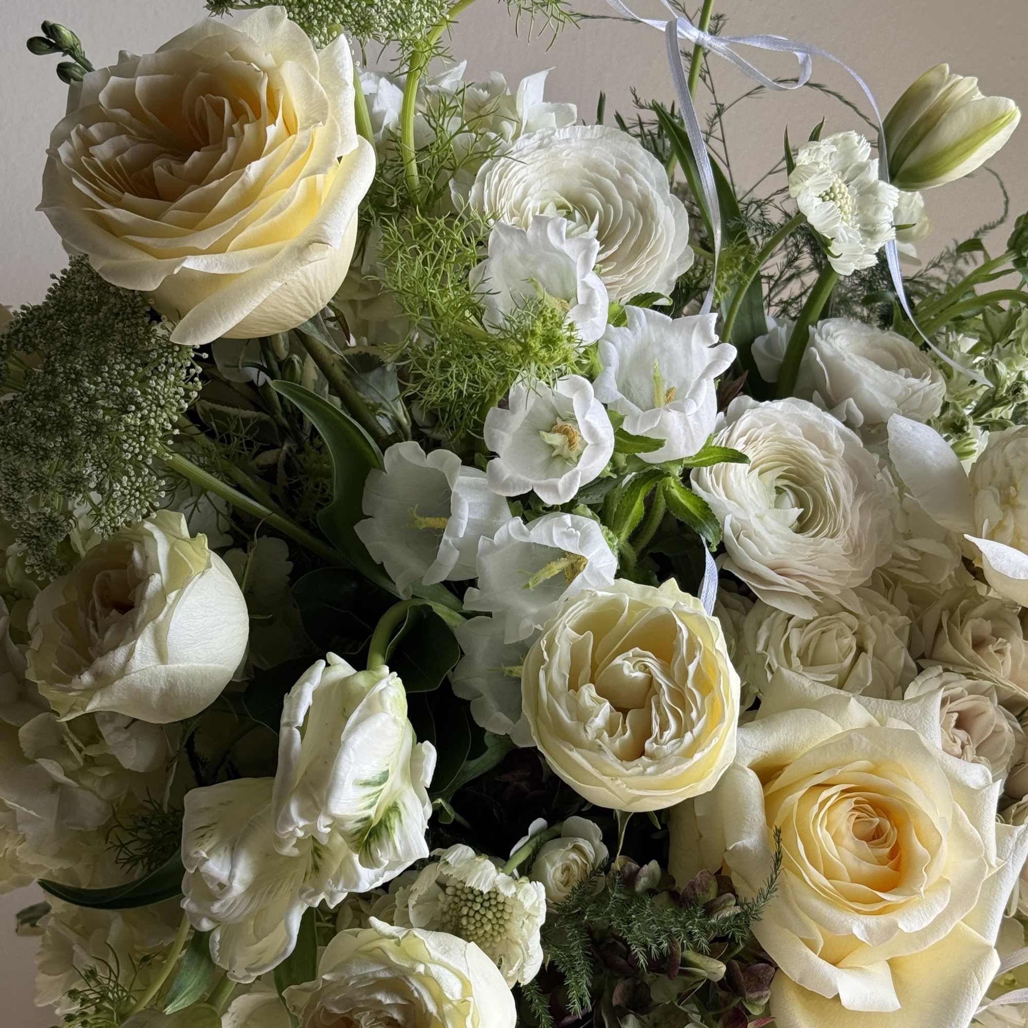 Cream and white bouquet with roses and ranunculus