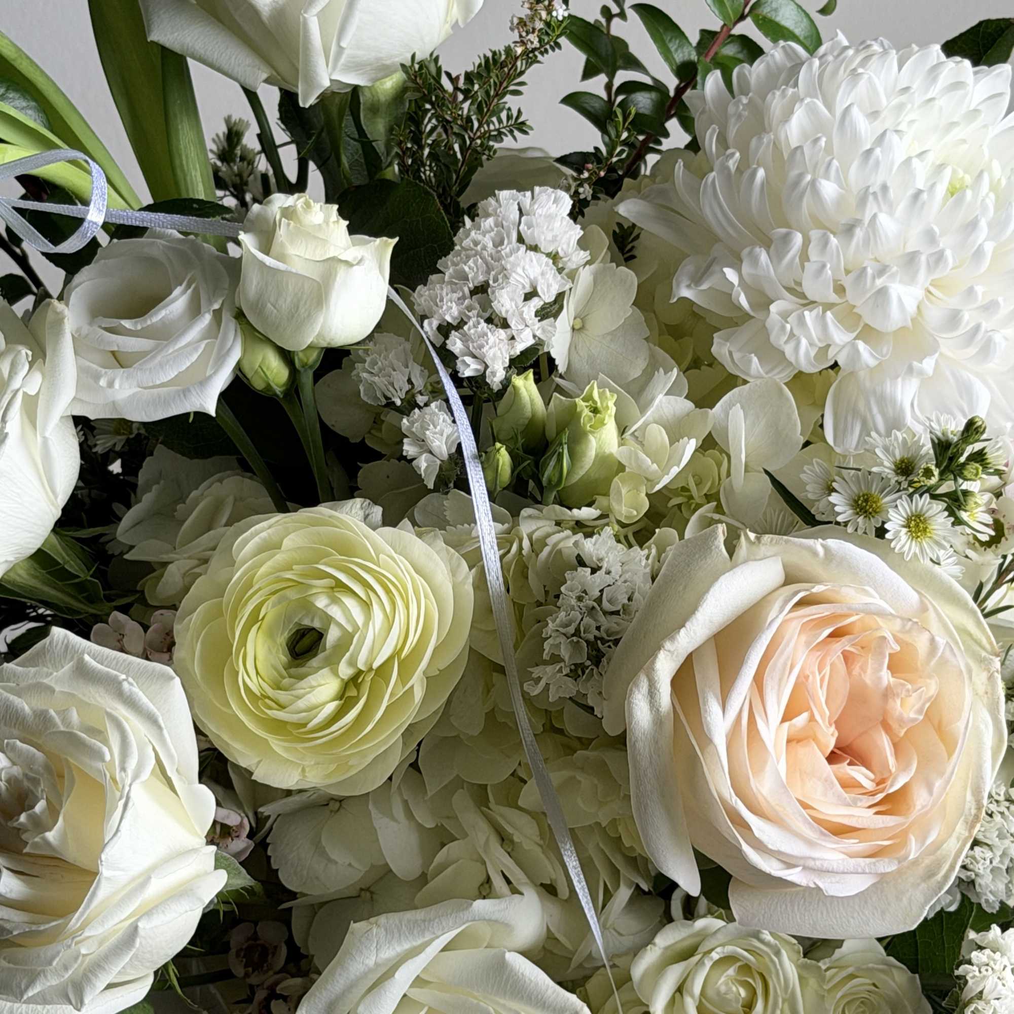 White rose and chrysanthemum bouquet with pale peach accents