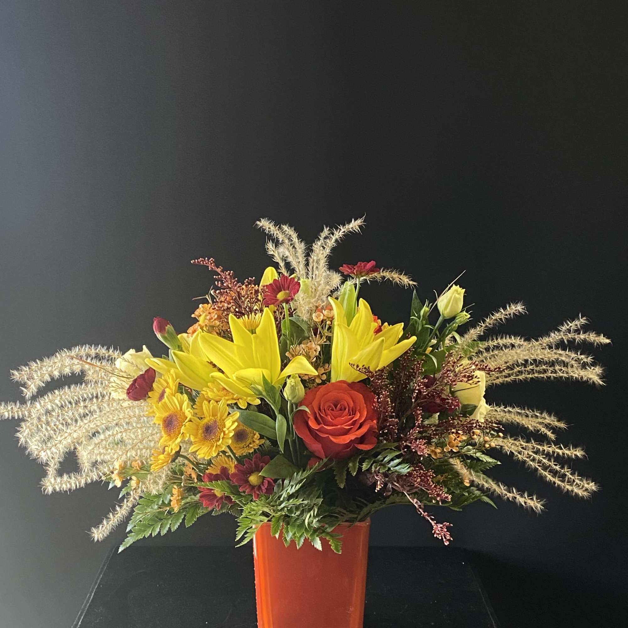 An arrangement that feels like a cozy fall day with fall leaves