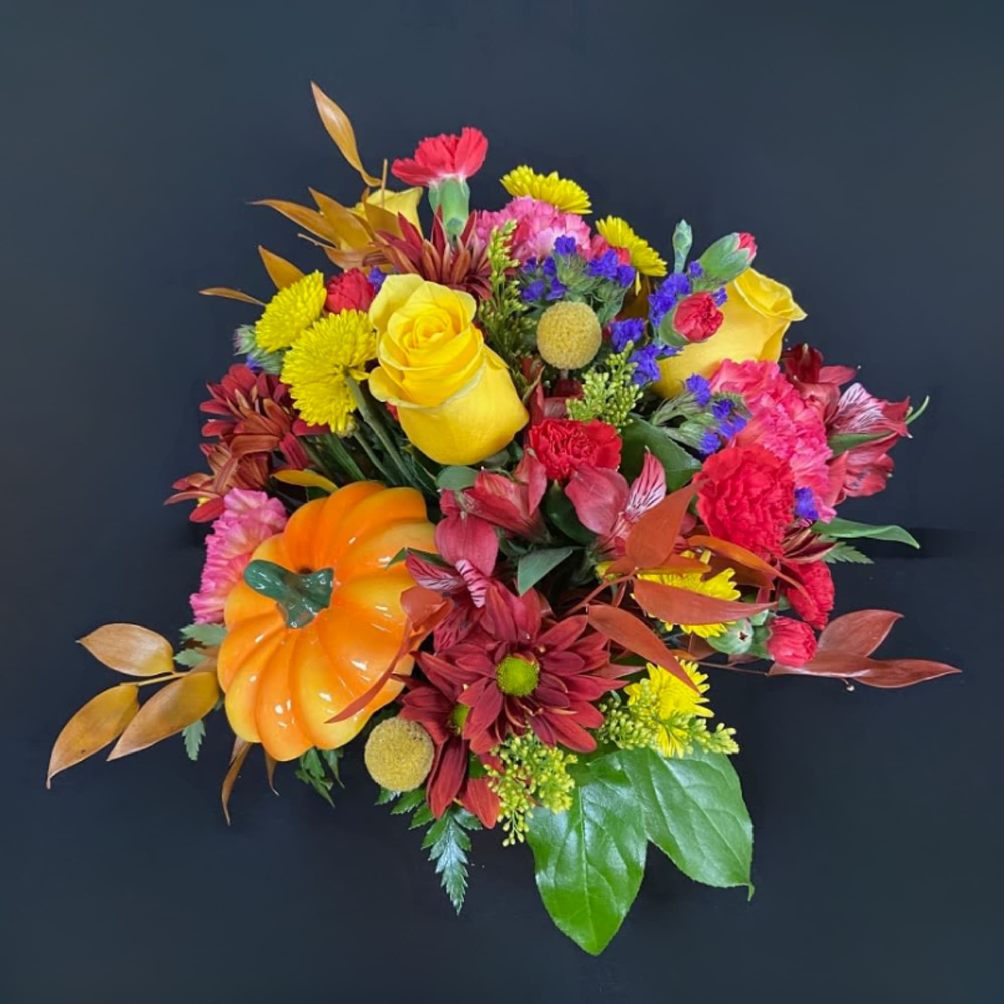 Colorful bouquet with yellow roses, chrysanthemums, and a pumpkin accent