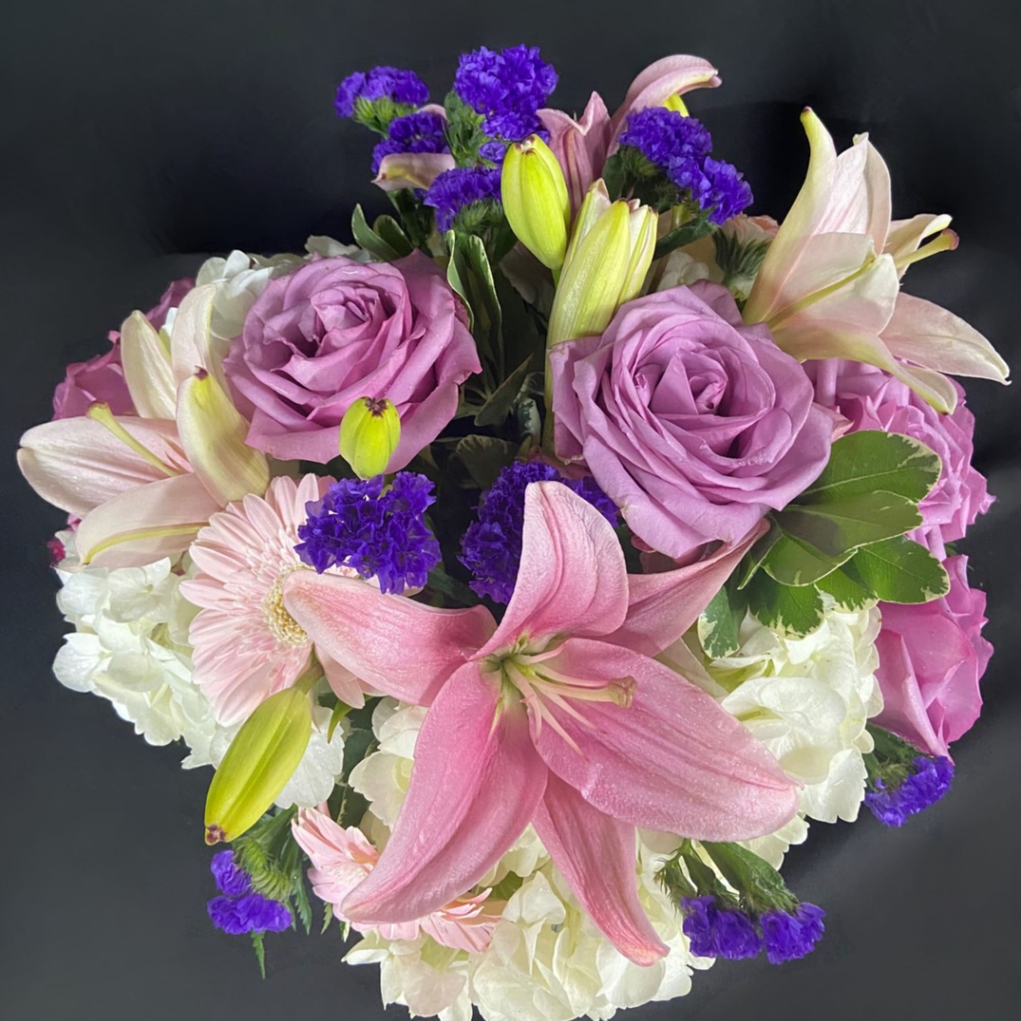 Pink and lavender bouquet with lilies, roses, and white hydrangeas