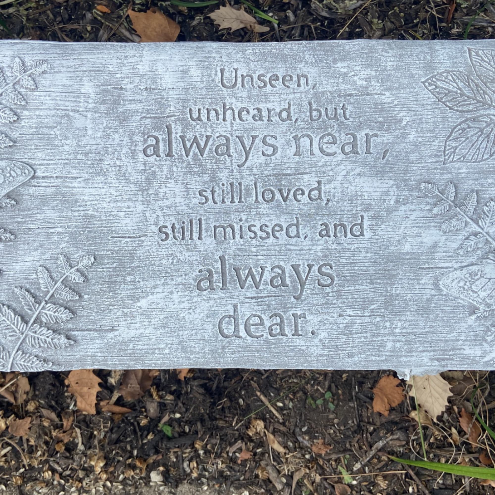 Gray memorial plaque with an engraved sympathy message