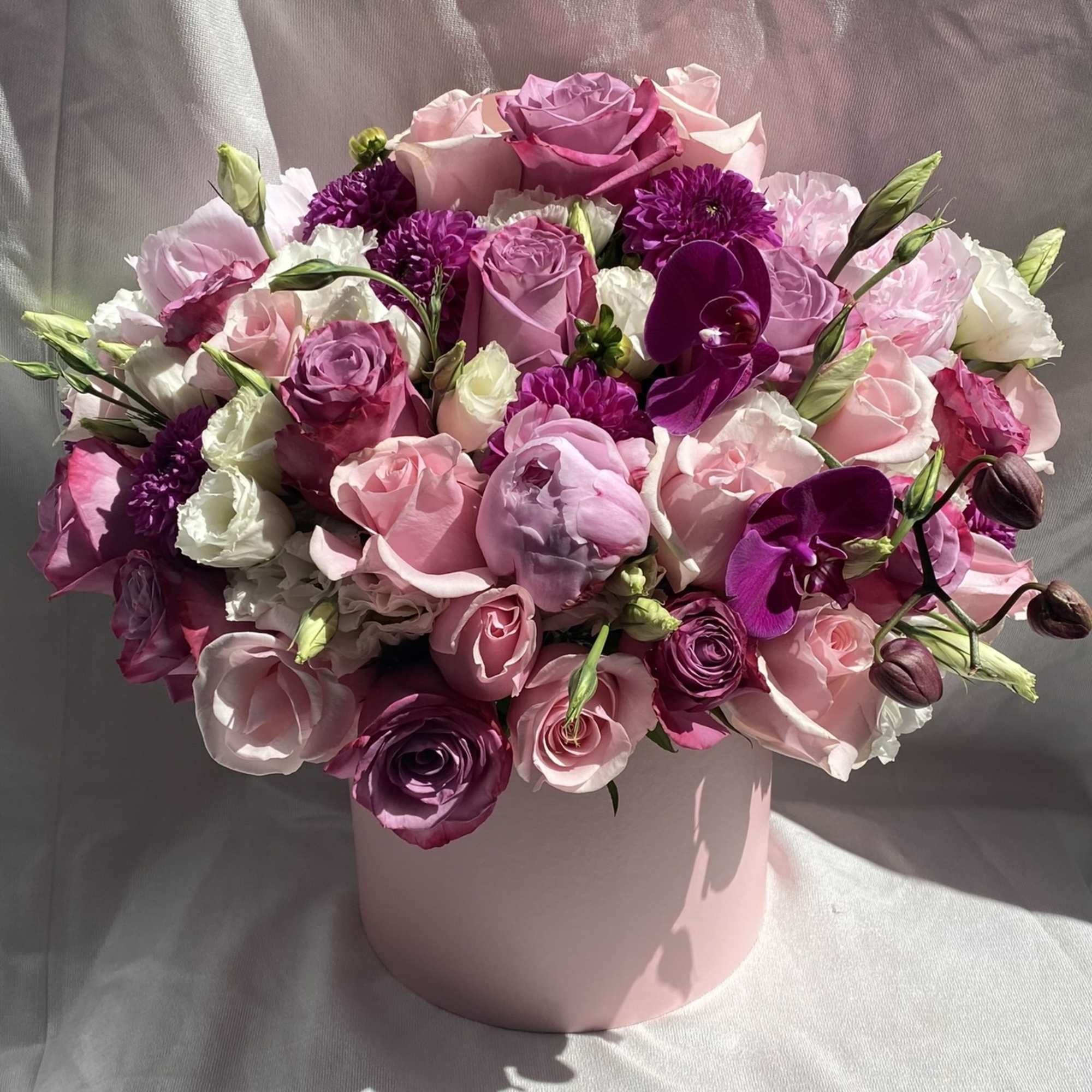 Pink and purple mixed bouquet in a pale pink hat box