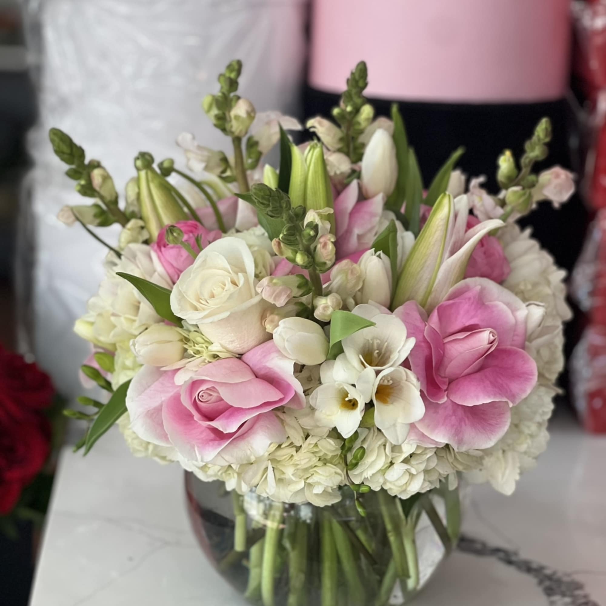Pink and white bouquet in a clear glass vase