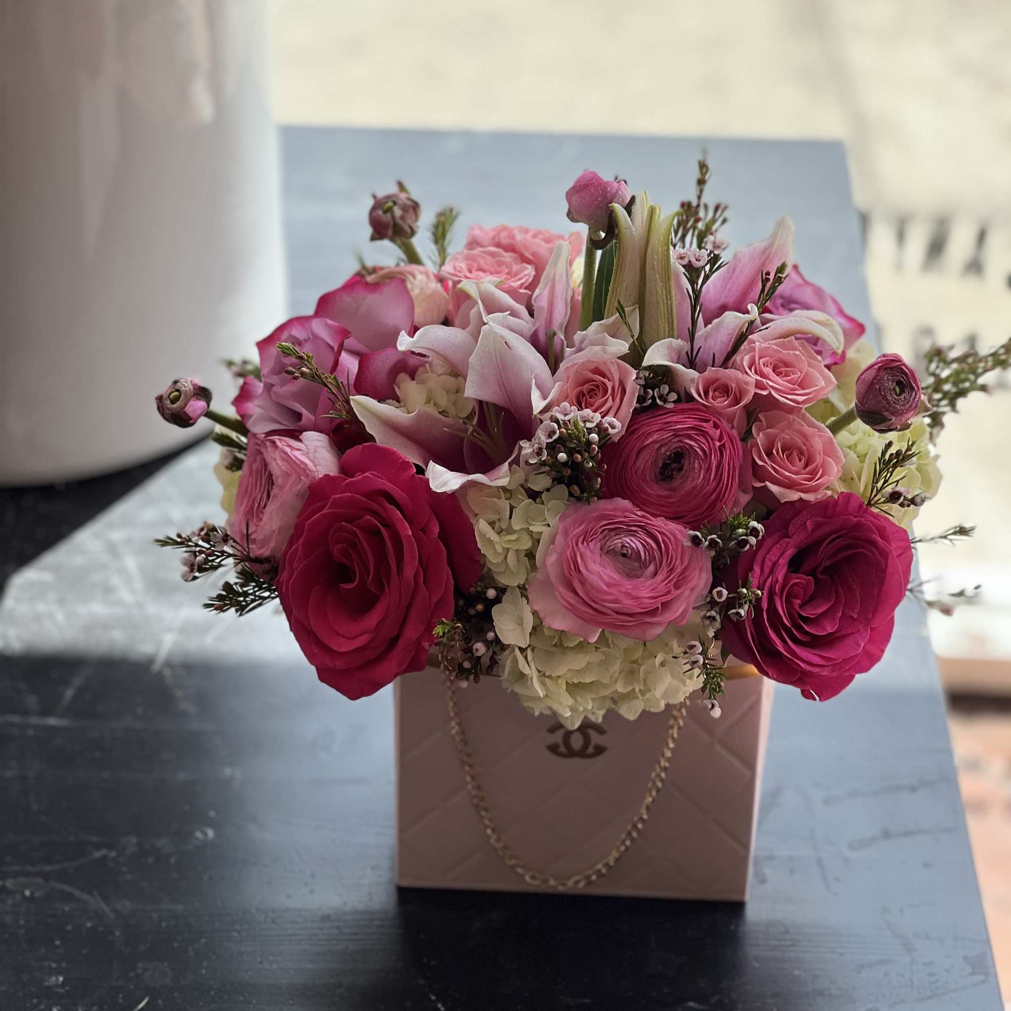 Pink floral arrangement in a blush gift box