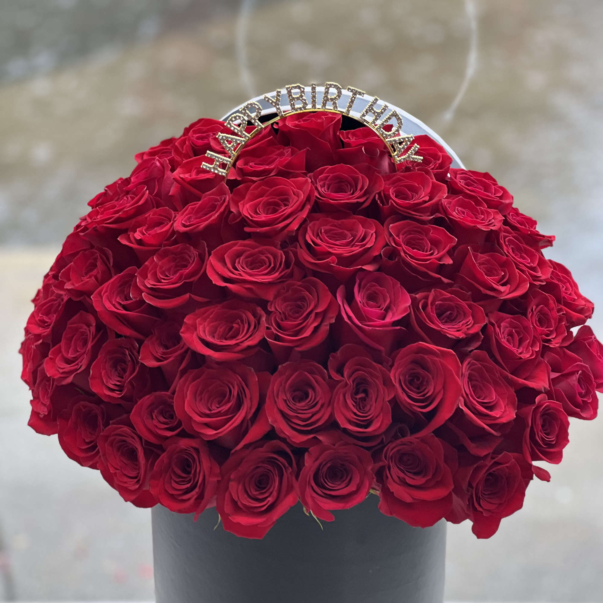Red rose bouquet in a black hat box with a birthday topper