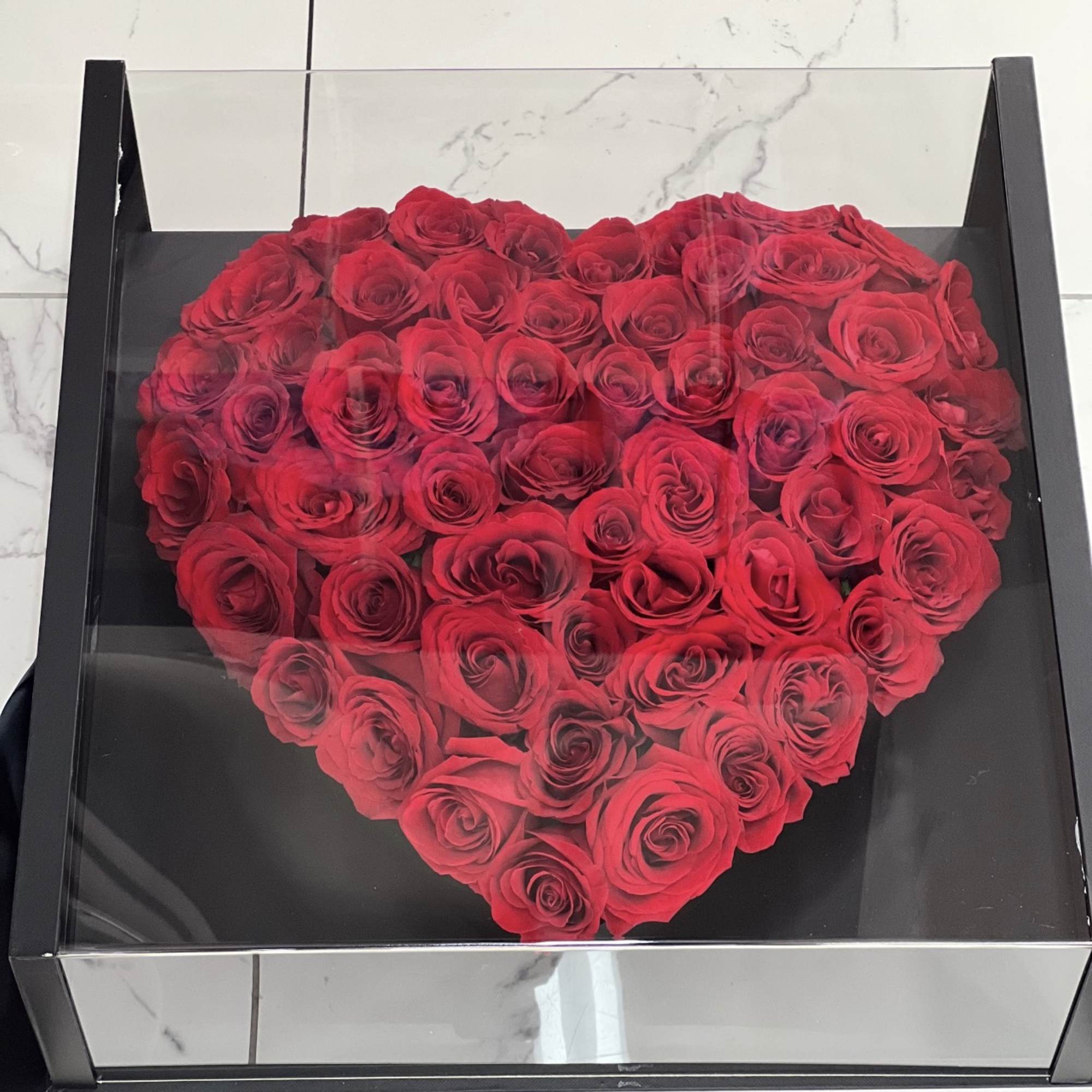 Heart-shaped box filled with red roses
