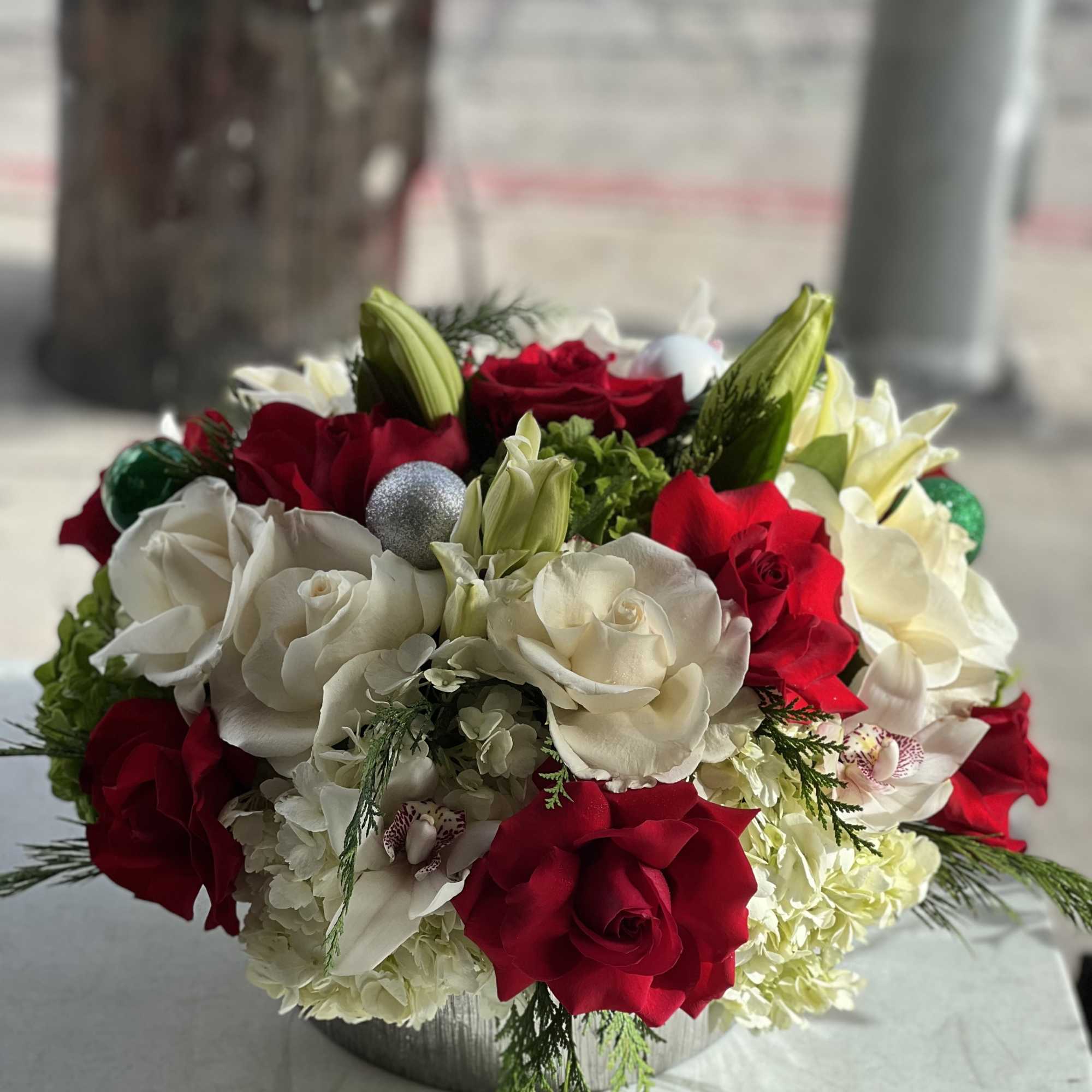 Red and white rose bouquet in a low round container