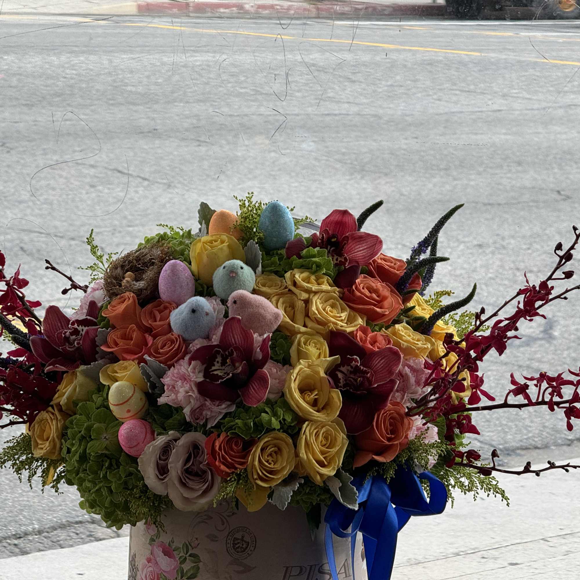 Colorful bouquet of roses with pastel Easter eggs in a box