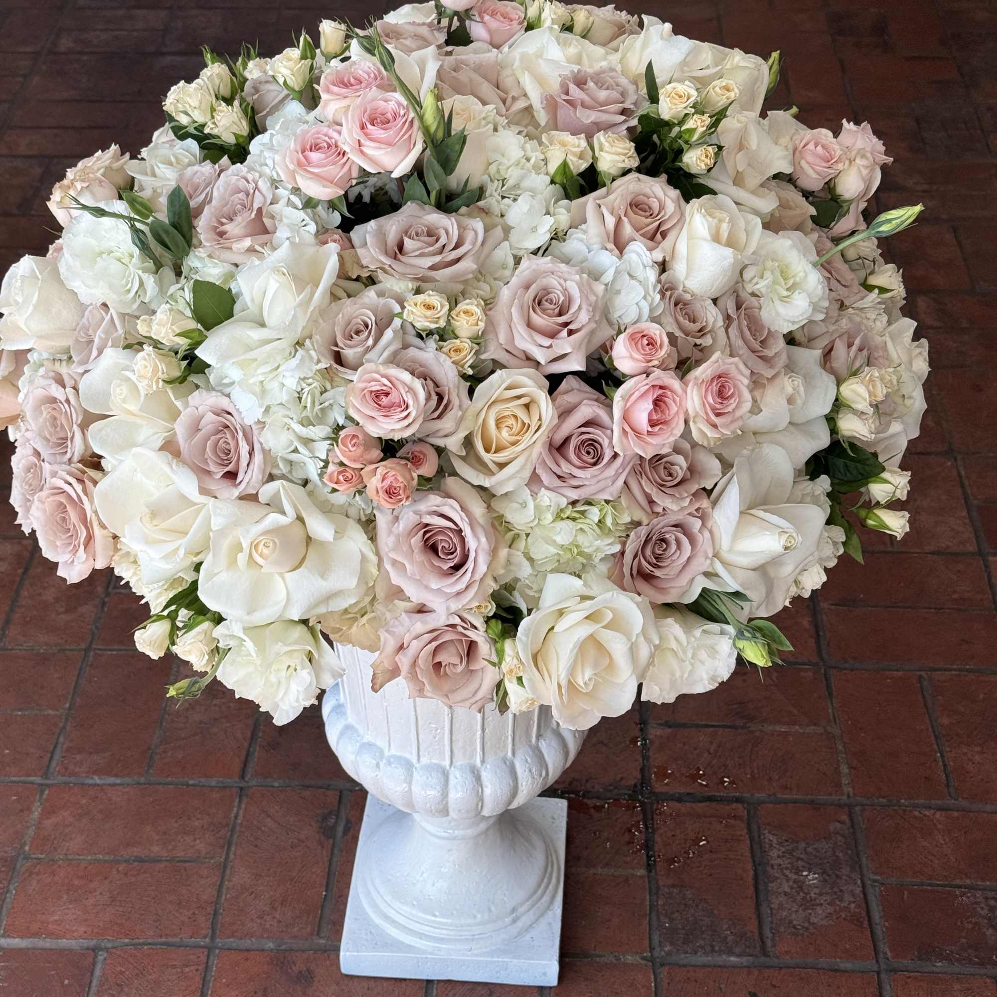 Large pastel rose arrangement in a white pedestal vase, photo 4 of 4
