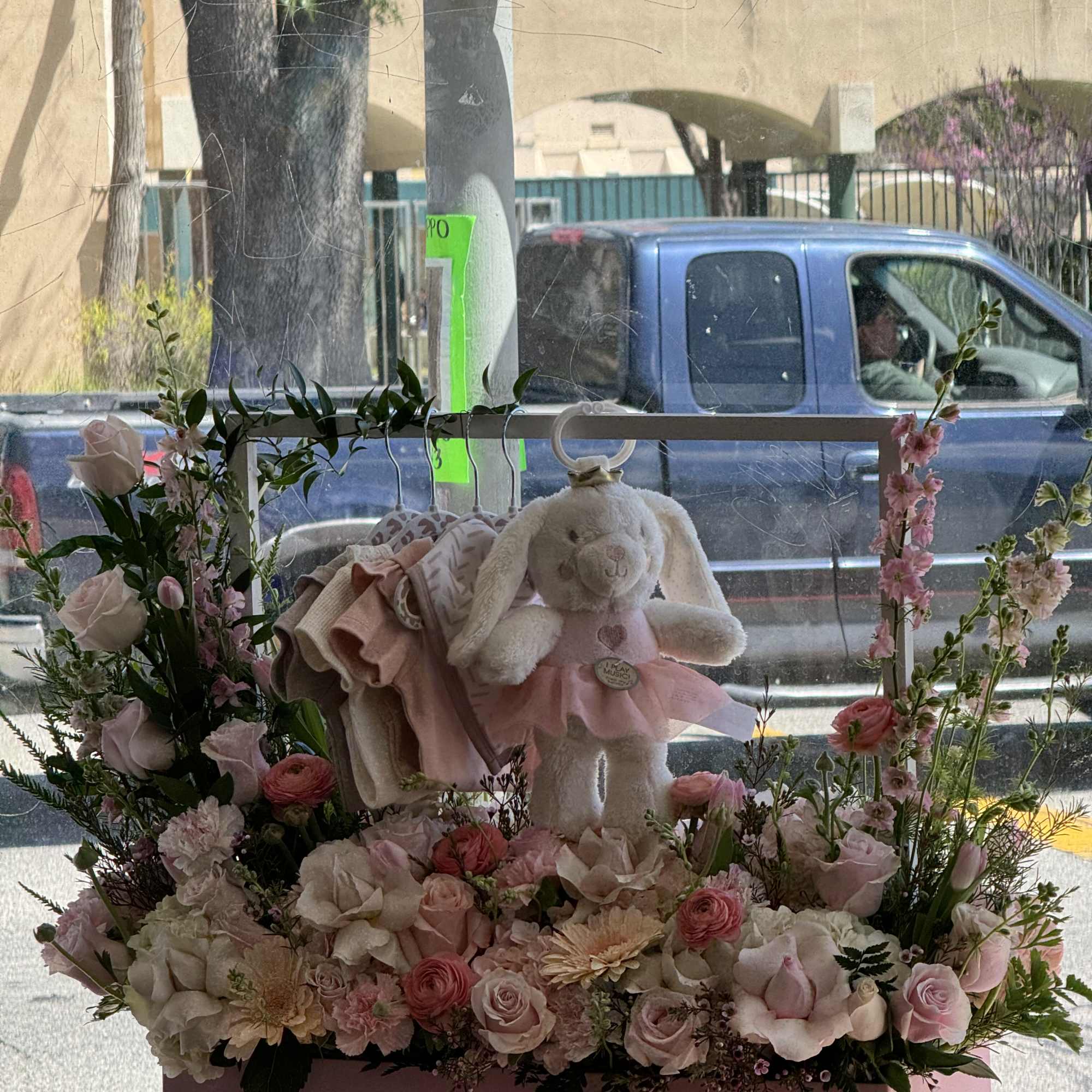 Pink floral gift box with a plush bunny and pastel flowers