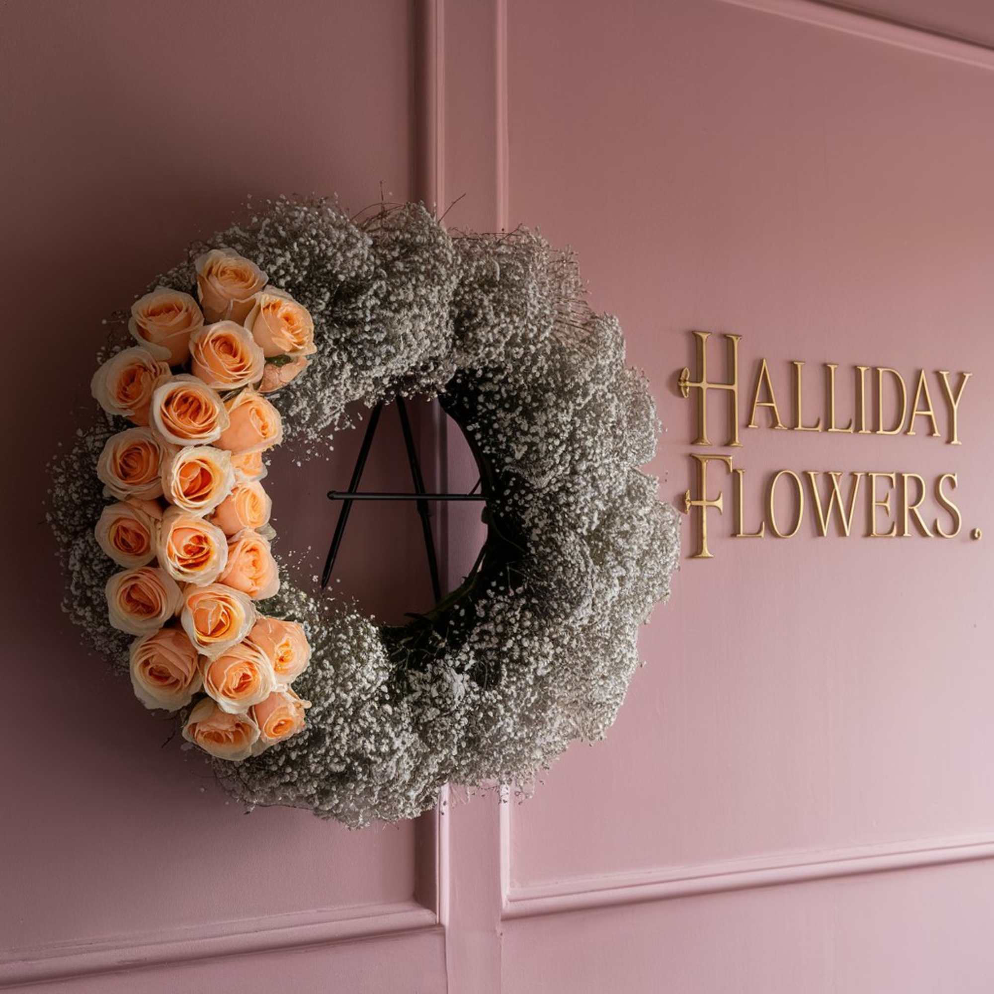 A 24-inch funeral wreath, exquisitely designed with delicate baby's breath and 