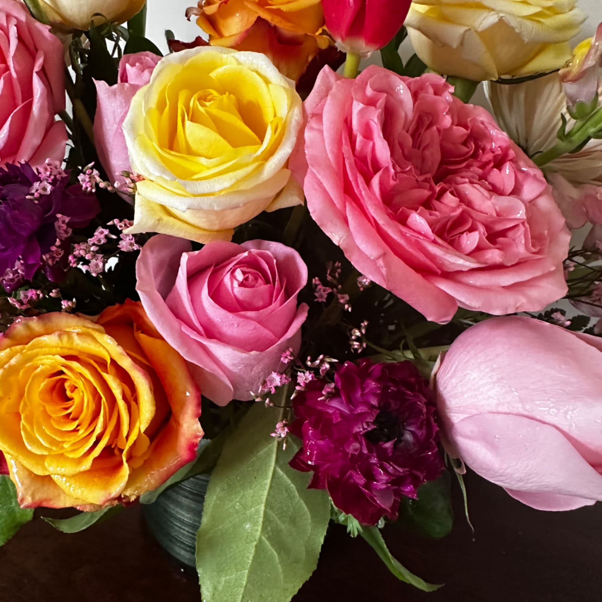 Close-up bouquet of multicolored roses in a vase