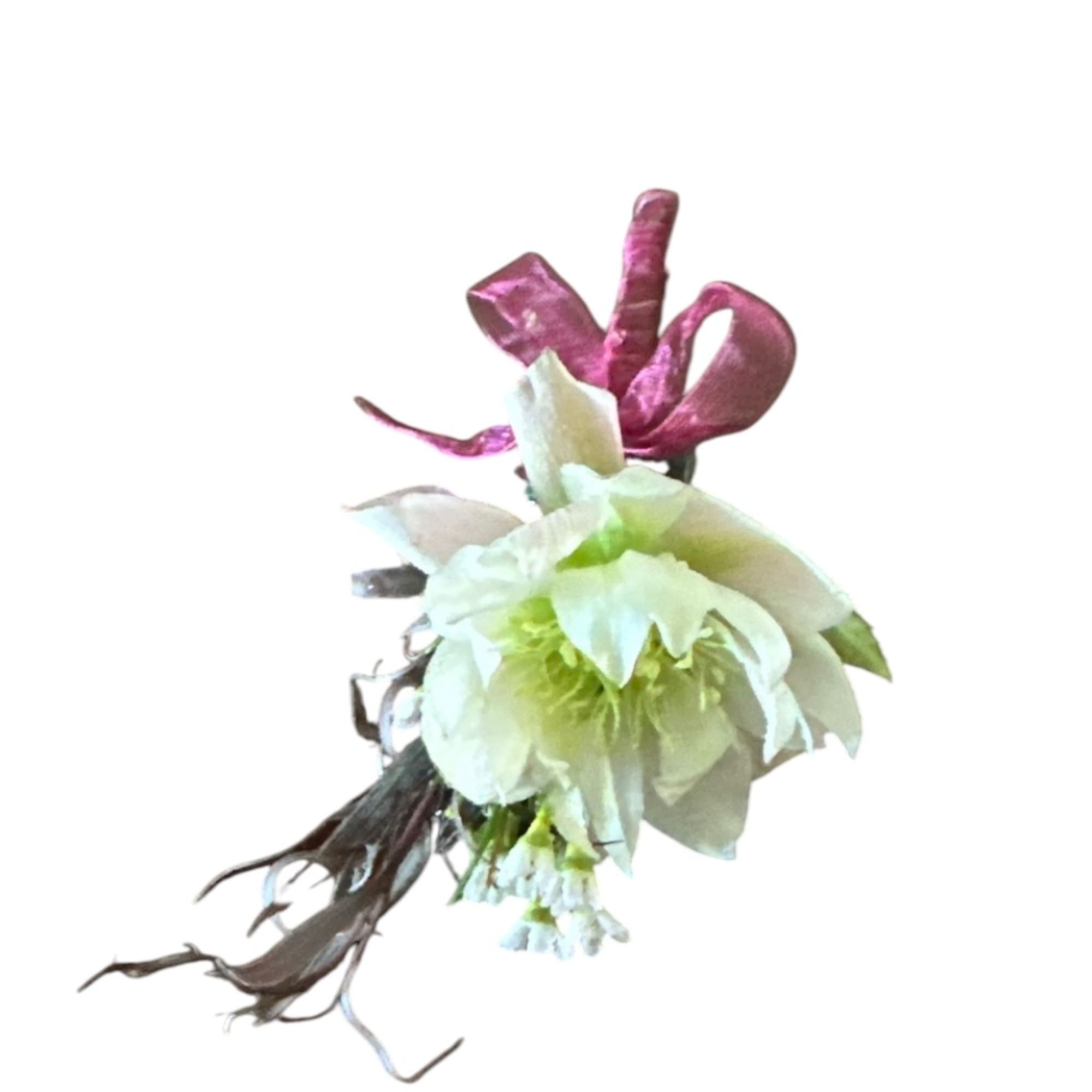 White flower with a pink ribbon accent on a small wrist corsage