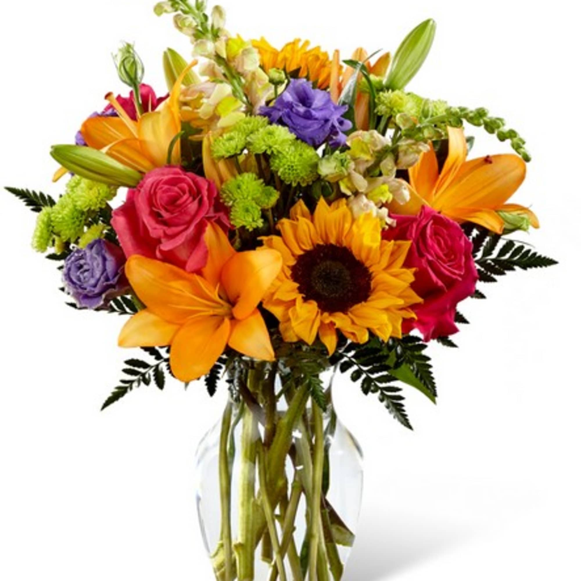 Colorful bouquet of lilies, roses, and a sunflower in a clear glass vase