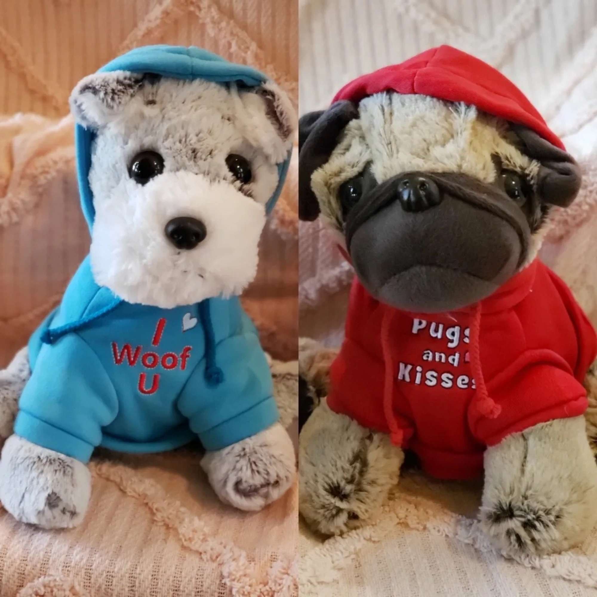 Two plush dogs in hoodies, one blue and one red, sitting side by side.