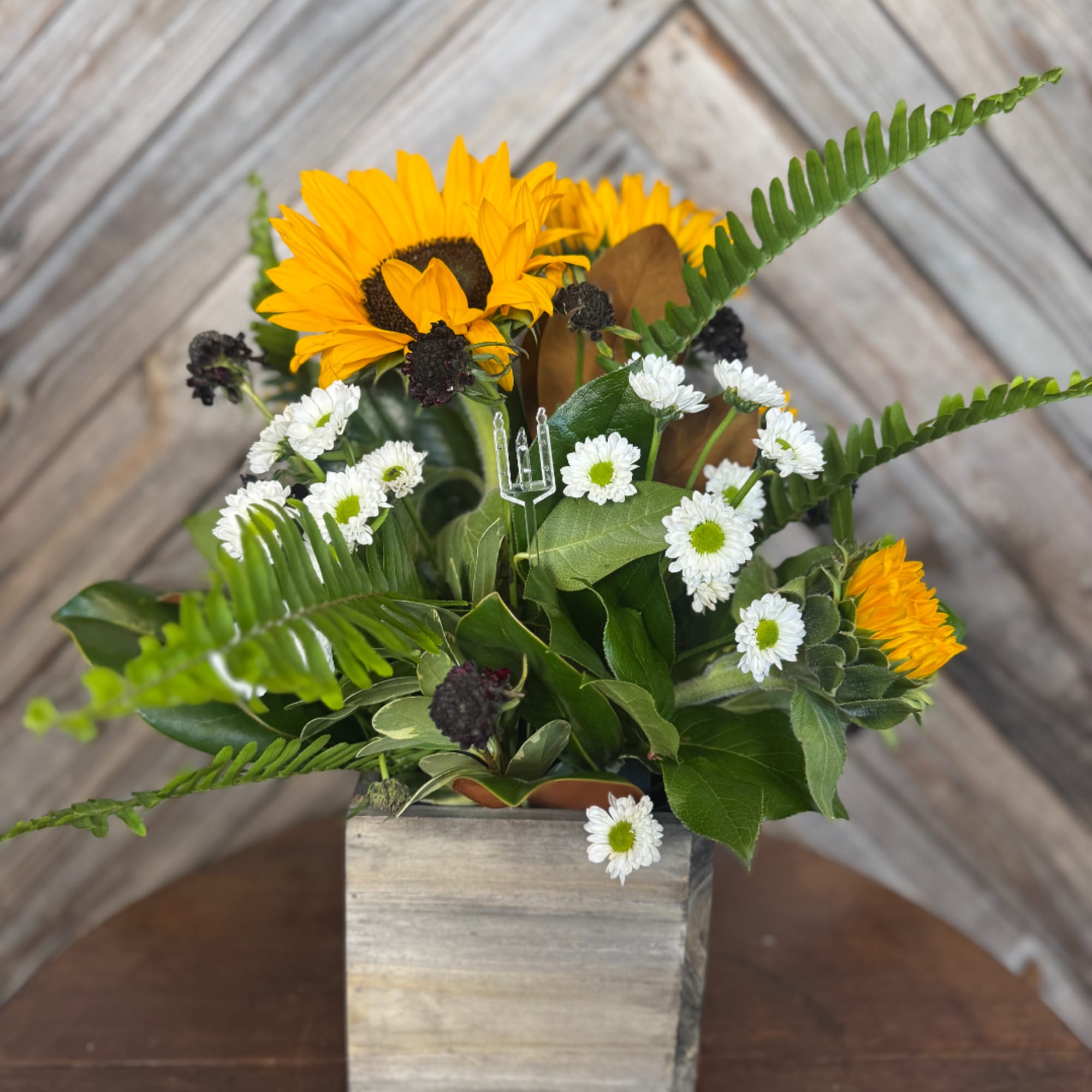 Sunflowers and white daisies in a wooden box arrangement