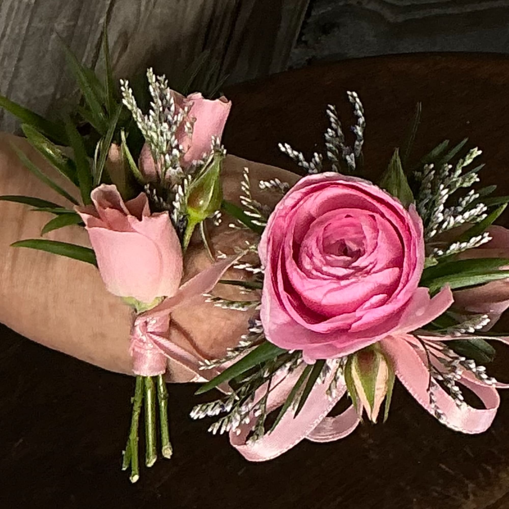 Pink rose and ranunculus wrist corsage with ribbon