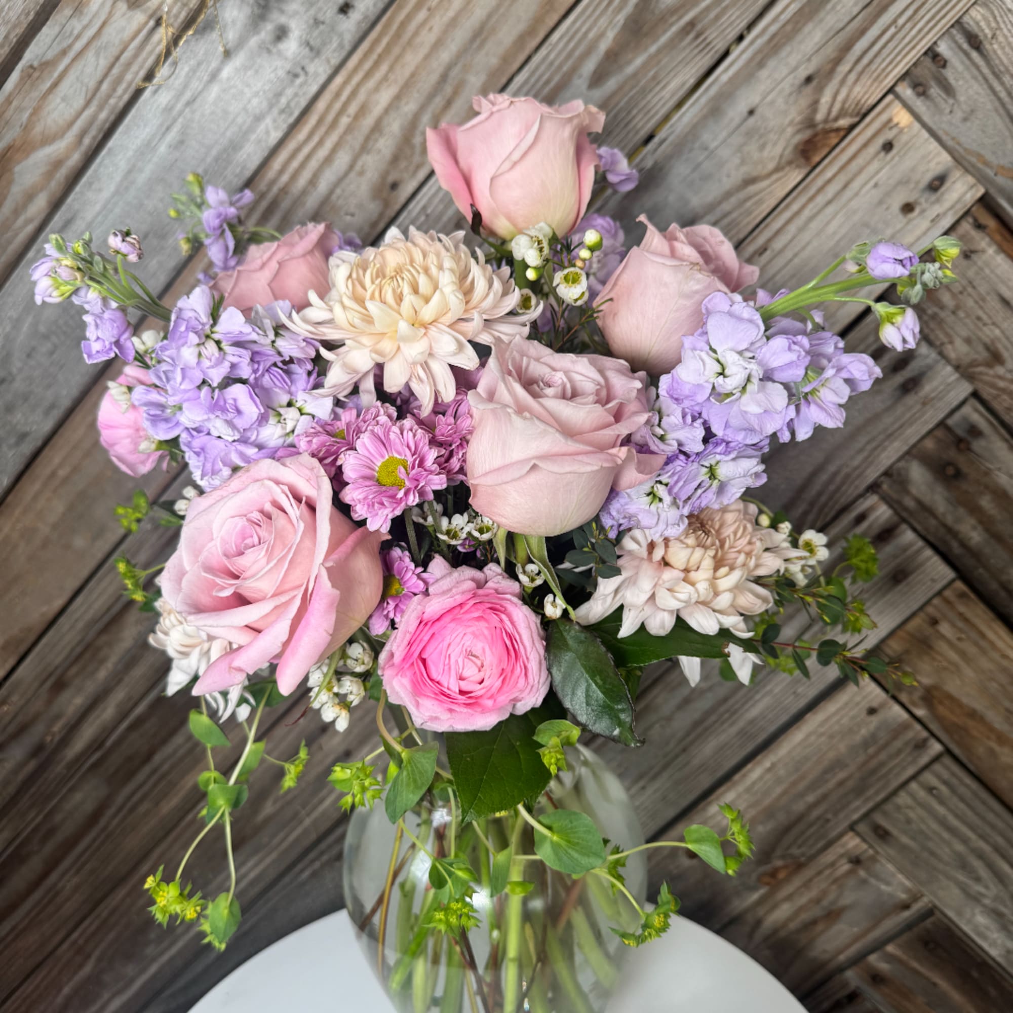 Pink and lavender mixed bouquet in a clear glass vase