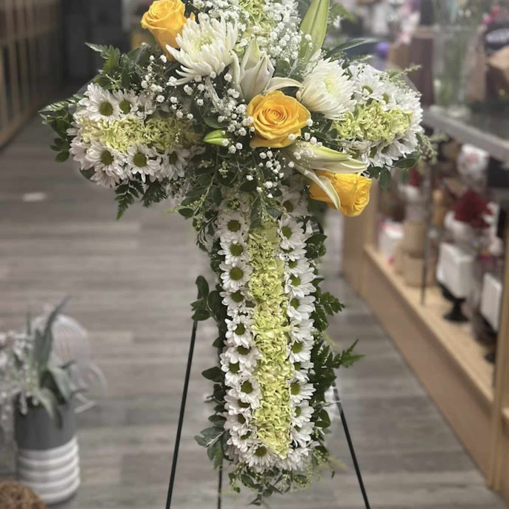 Cross-shaped floral standing spray with white daisies and yellow roses