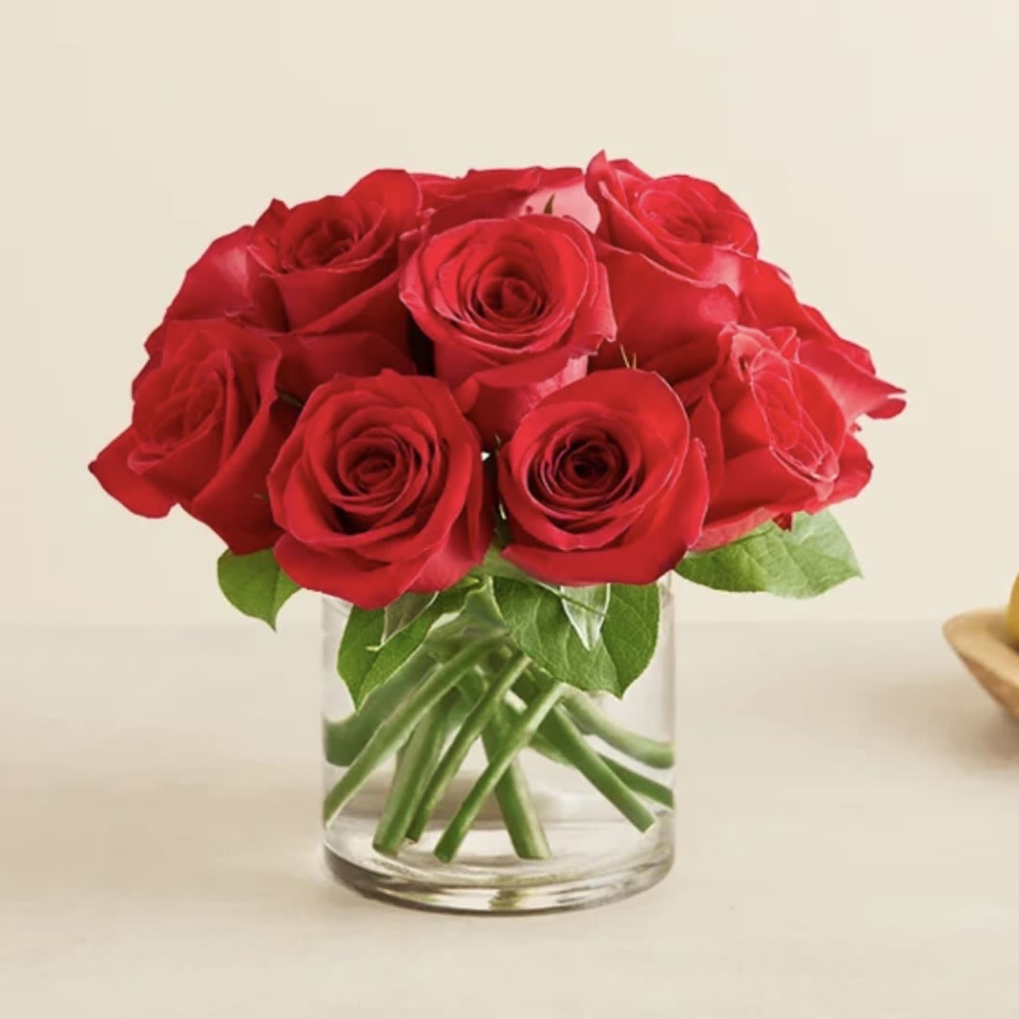 Red roses arranged in a clear glass vase