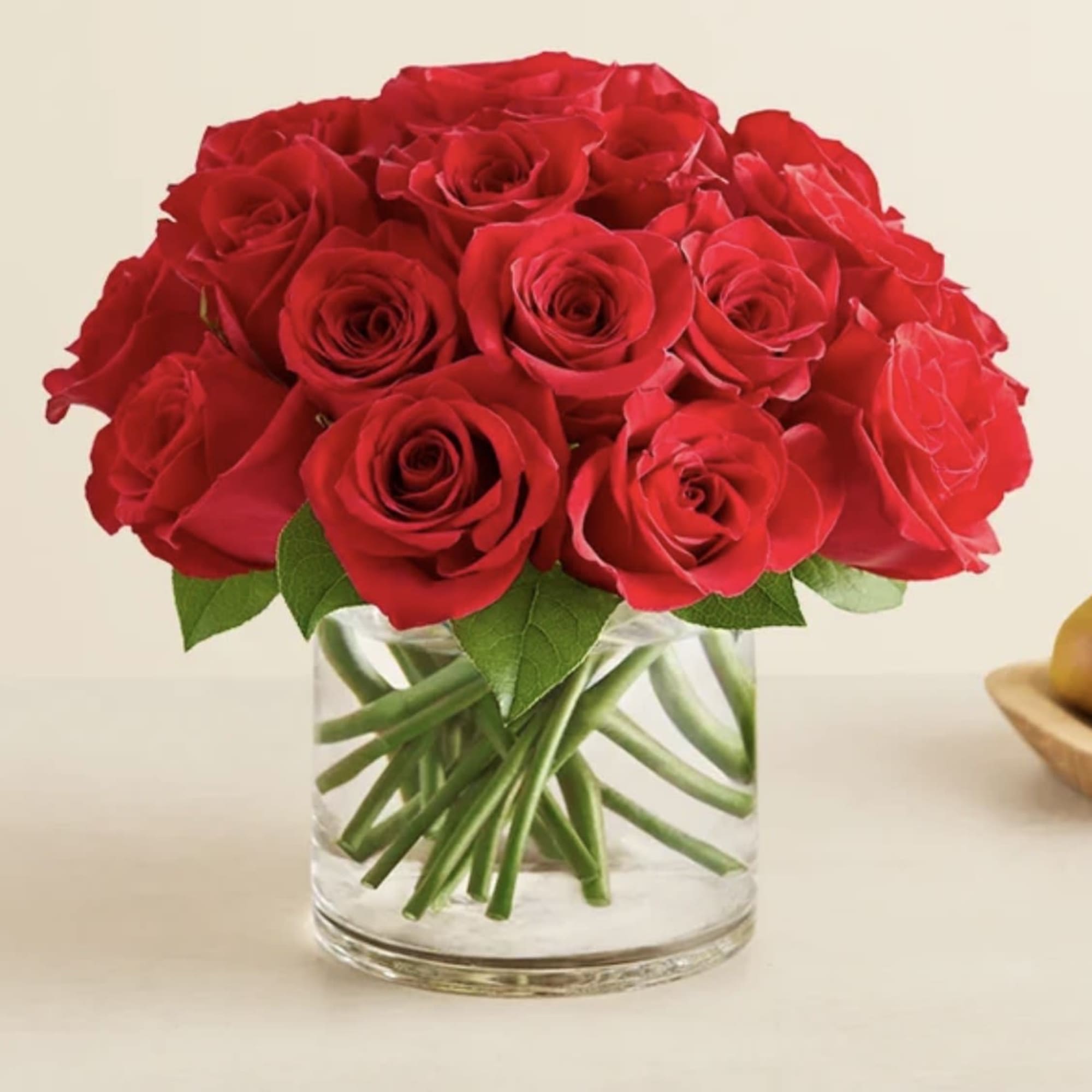 Red roses arranged in a clear glass vase