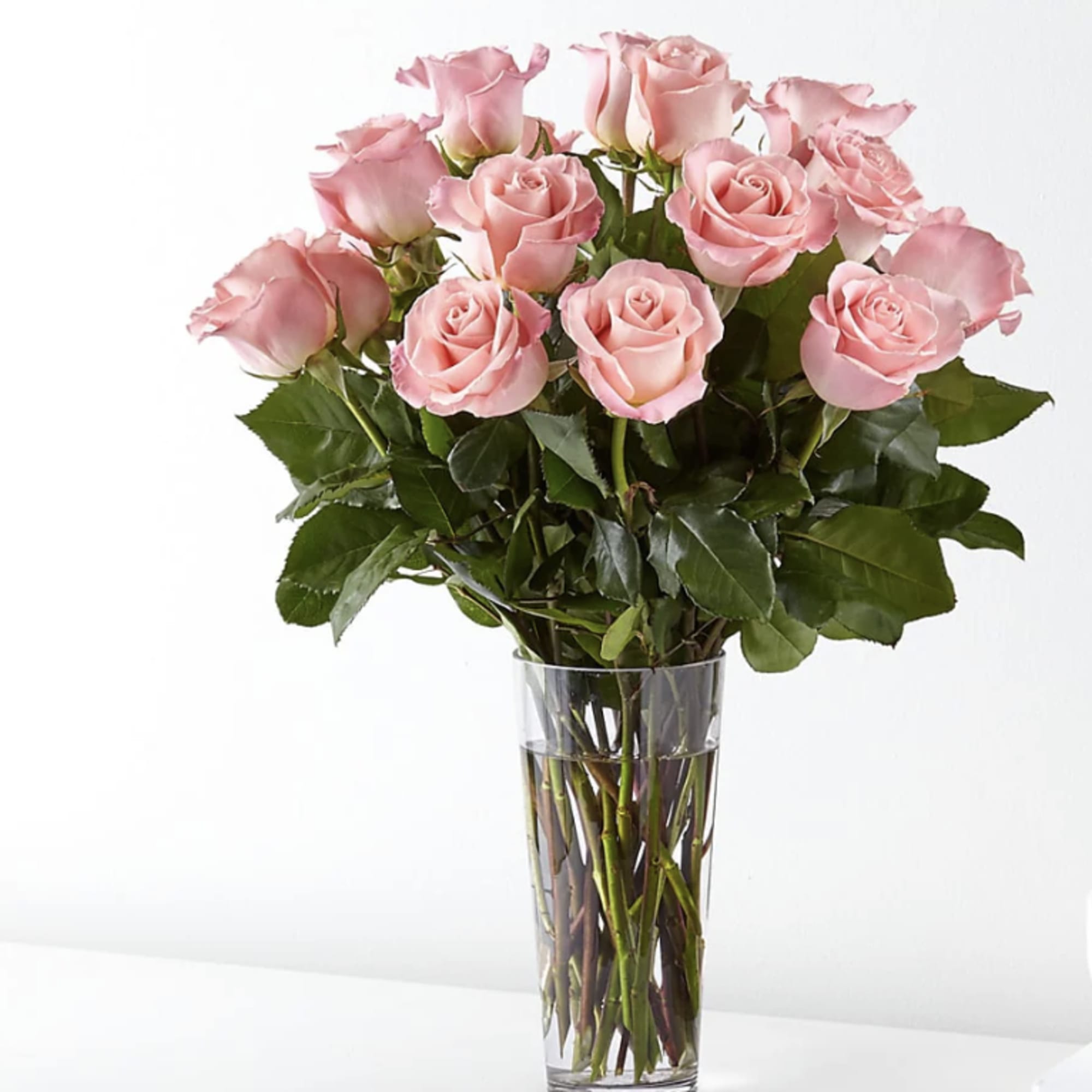 Pink roses arranged in a clear glass vase