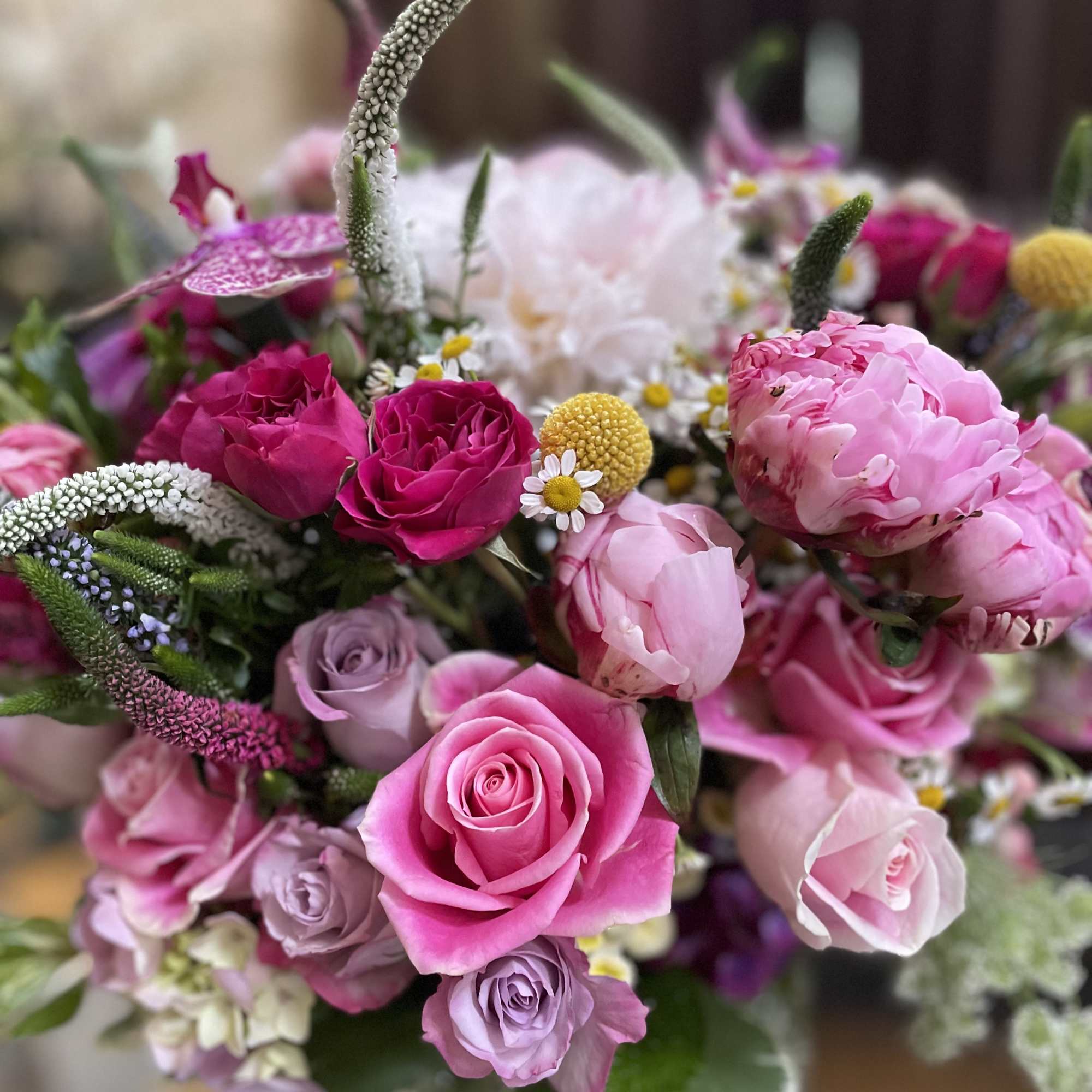 Pink and lavender rose bouquet with peonies and small daisies