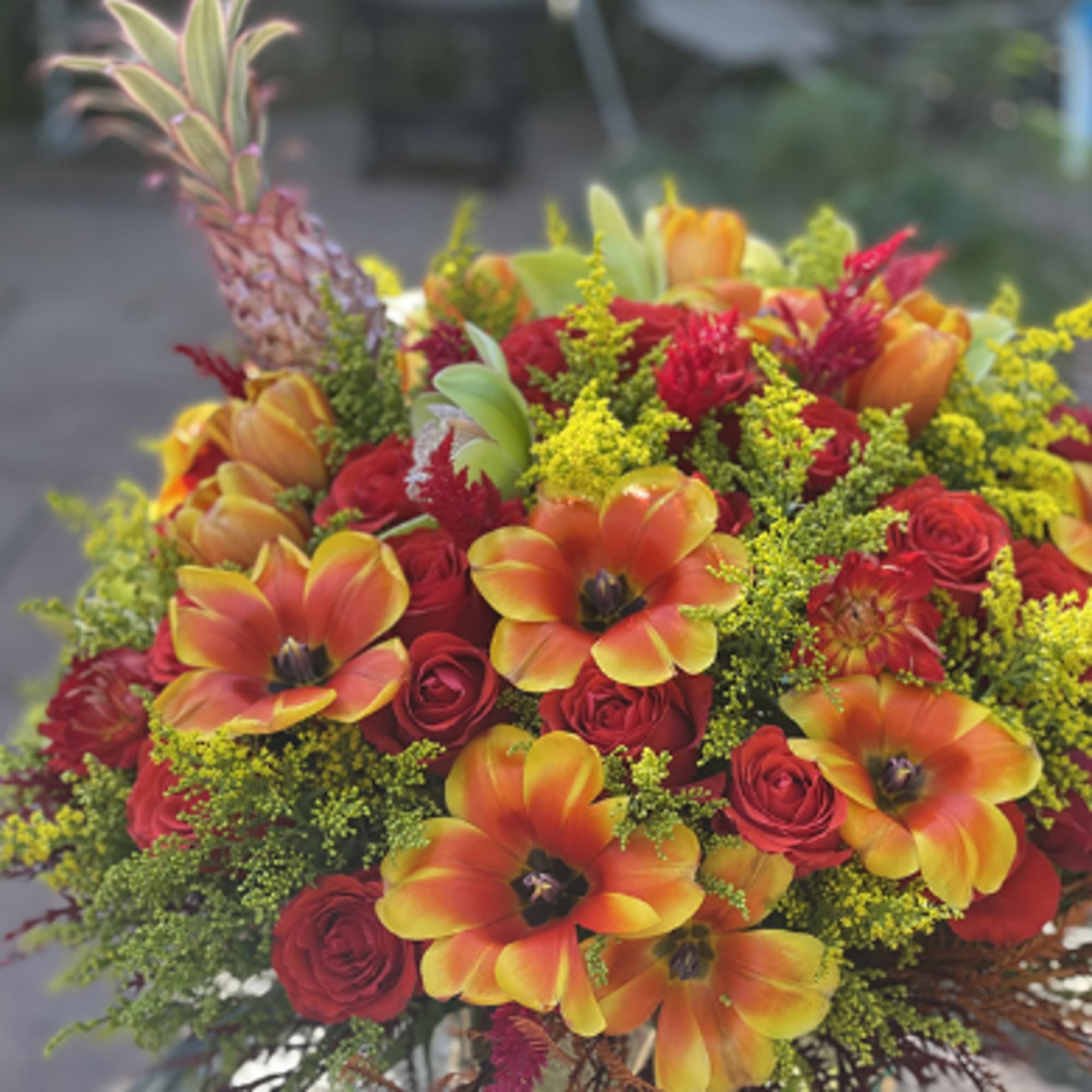 Bouquet of red roses and orange tulips with yellow filler flowers