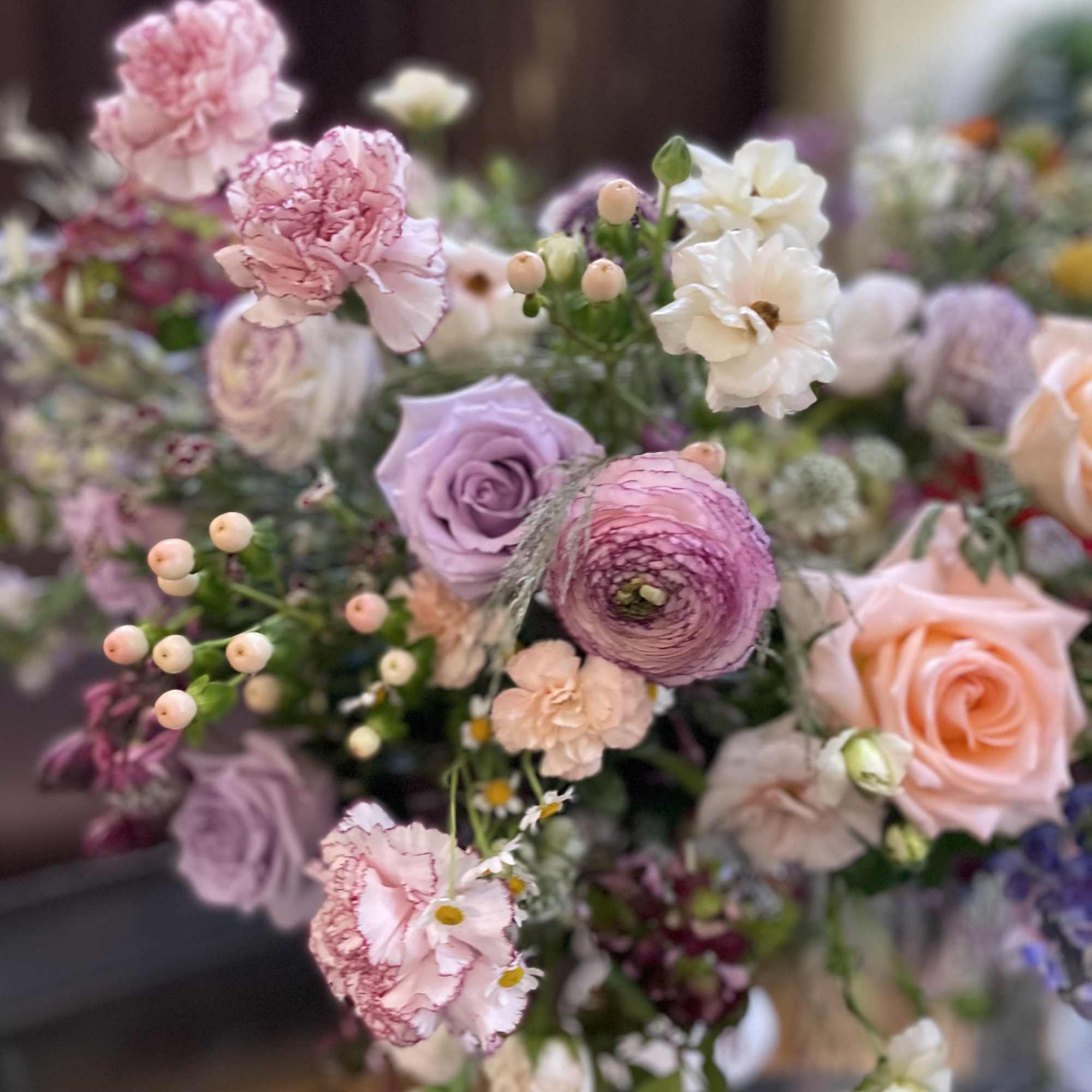 Pastel bouquet with pink carnations, roses, and white blooms