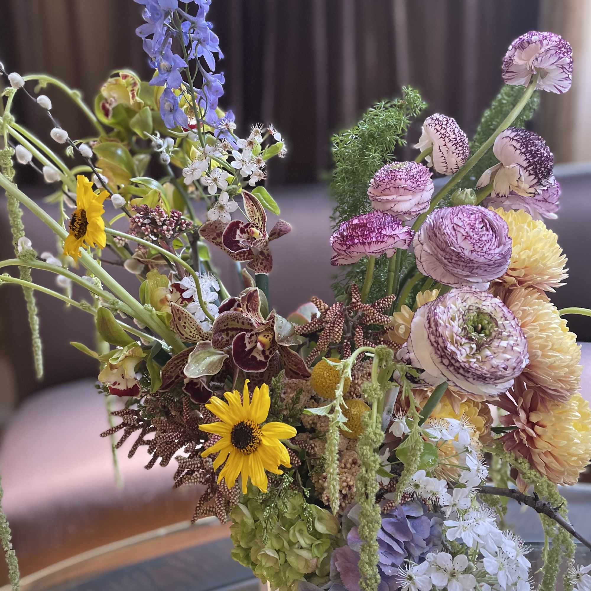 Mixed bouquet with purple, yellow, and white flowers in a vase