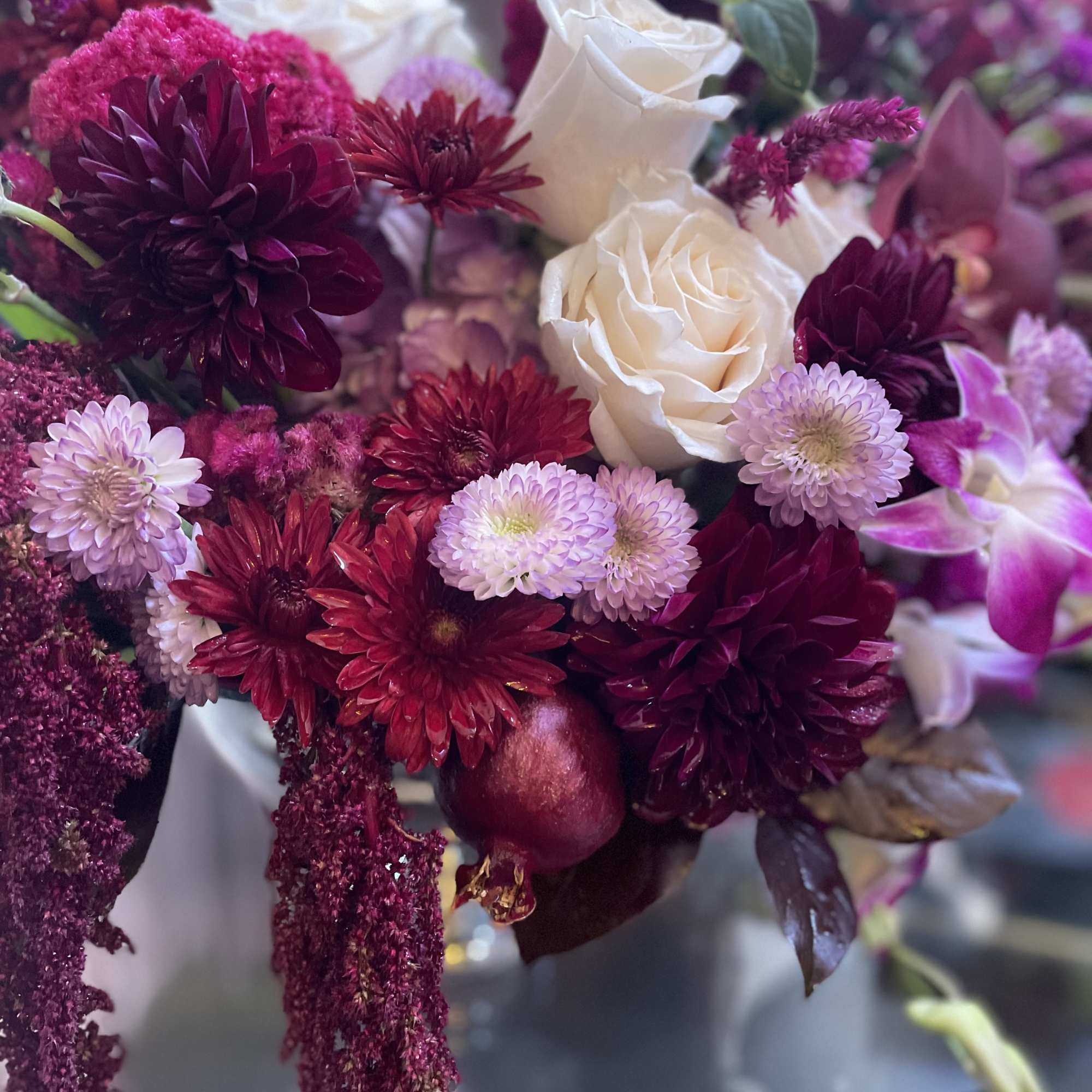 Bouquet of white roses and burgundy flowers with hanging amaranthus